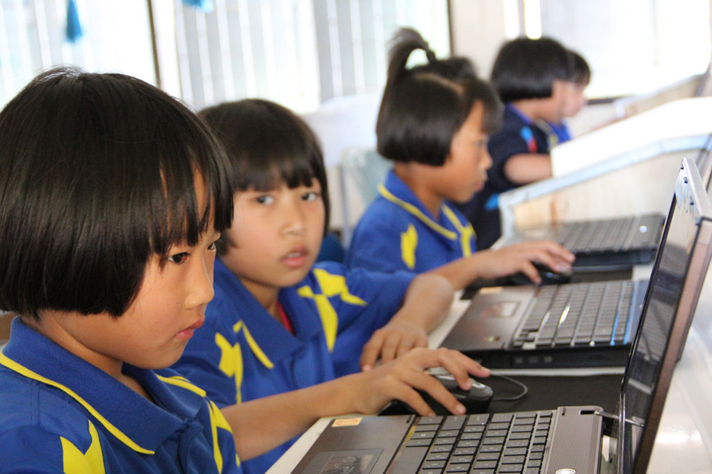 Young students learn their computer skills to prepare themselves for the future. Chiang Rai, Thailand, January 2012