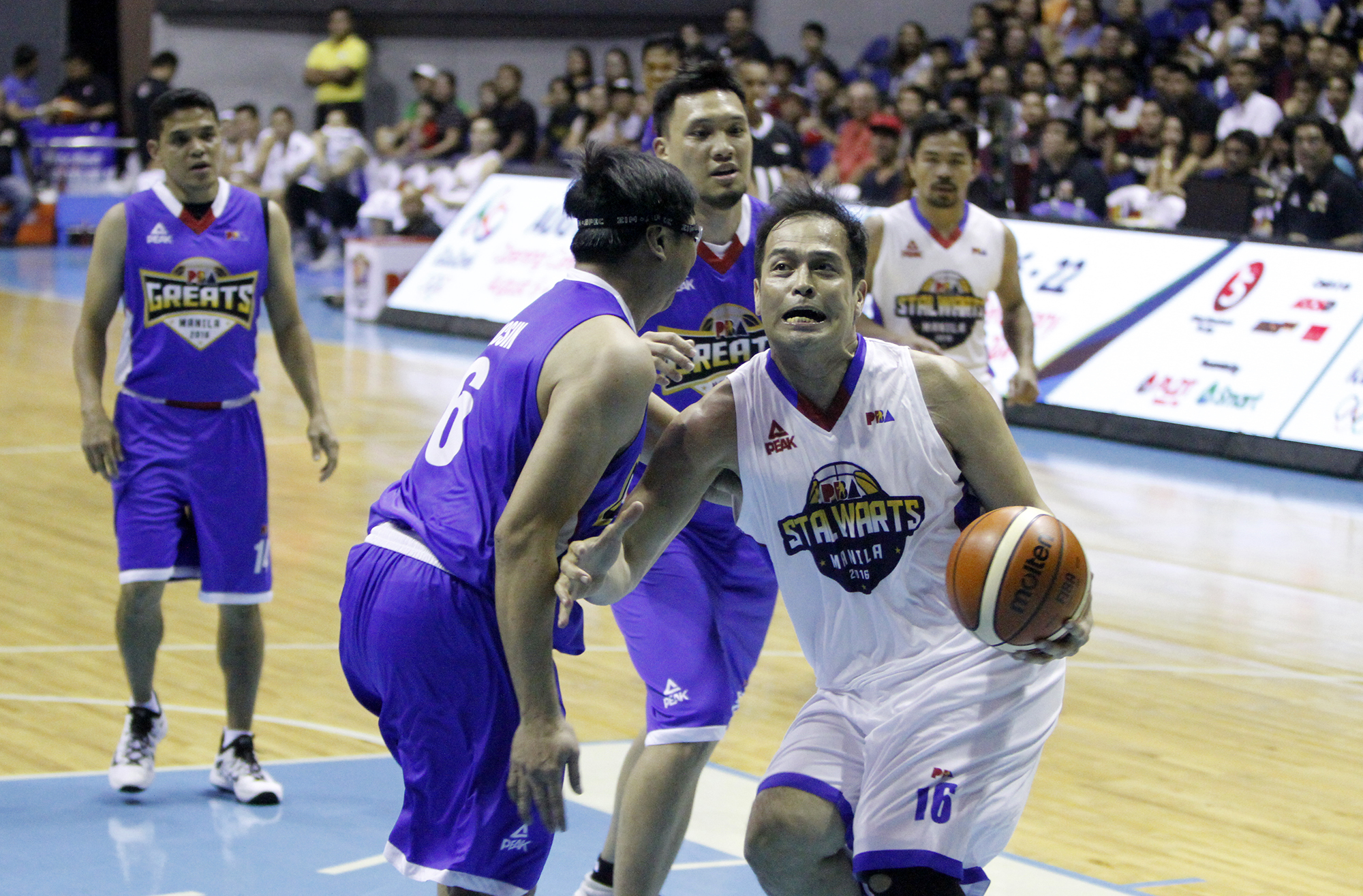 CUBAO, Philippines - PBA Stalwart Alvin Patrimonio (#16) drives against PBA Great Noli Locsin (#6) during the Blitz Game on PBA All-Star Friday night at the Smart Araneta Coliseum. (Photo courtesy: PBA Images)