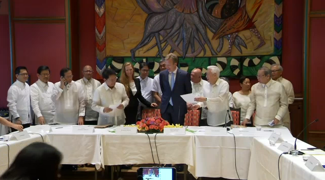 The Philippine government and the National Democratic Front sign an indefinite ceasefire deal to facilitate peace talks aimed at ending one of Asia's longest-running insurgencies.  (Photo grabbed from AFP video)