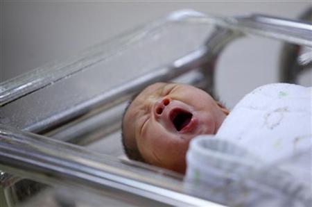 A baby yawns inside the maternity ward of a hospital in Taipei March 31, 2010.   REUTERS/Nicky Loh