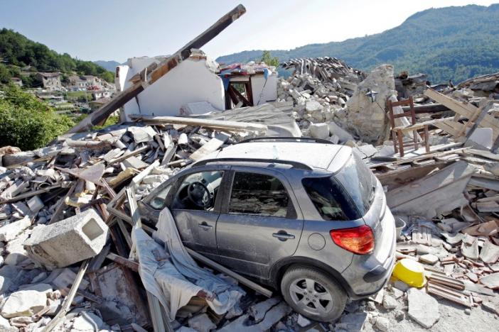 A car covered by debris is seen near a collapsed house following an earthquake in Pescara del Tronto, central Italy August 26, 2016. REUTERS/Max Rossi