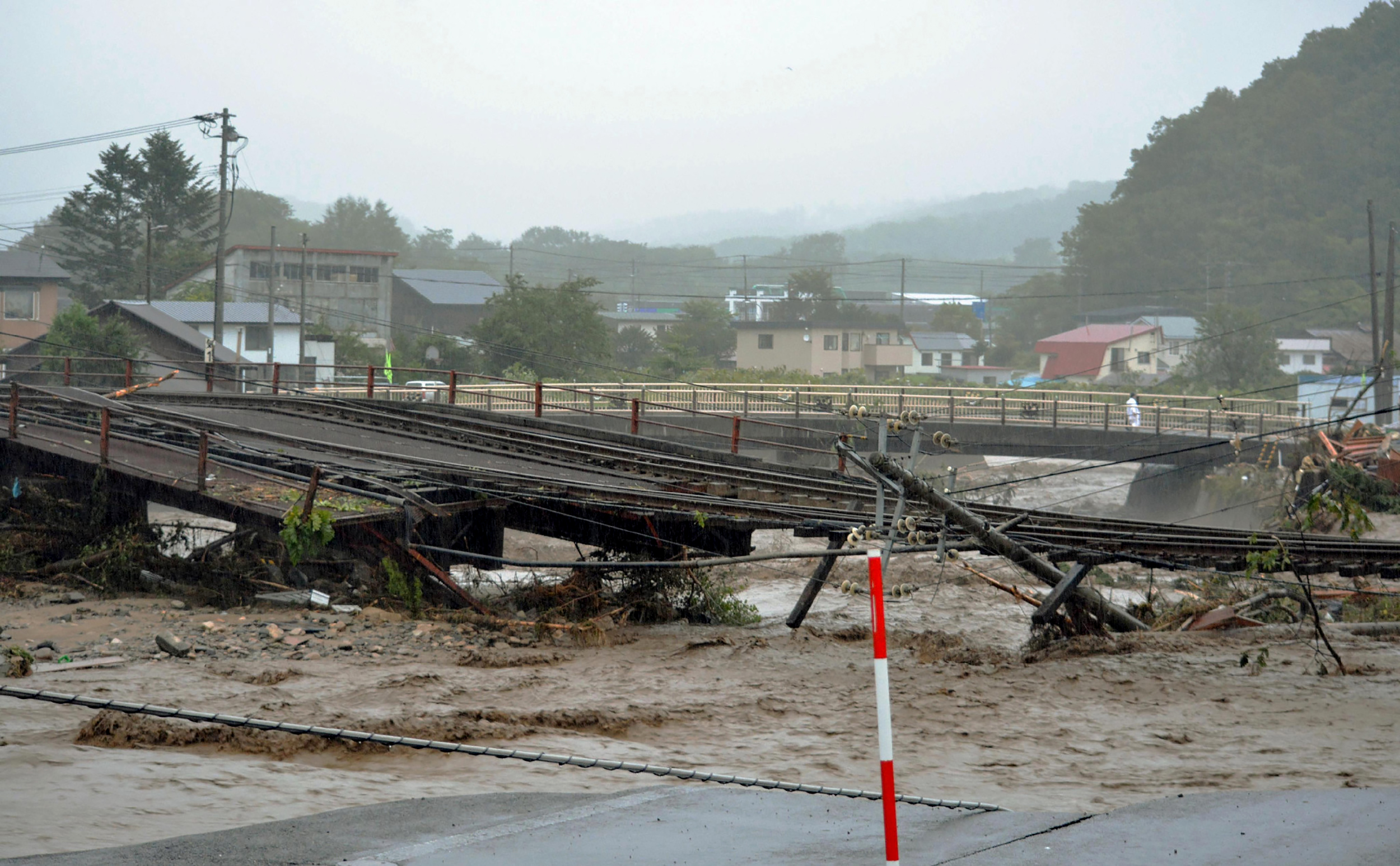 This picture provided by Tokachi Mainichi Newspaper via Jiji Press on August 31, 2016 shows a damaged railroad from flooding in the town of Shintoku in Hokkaido prefecture, after Typhoon Lionrock struck overnight. Ten people were found dead in northern Japan -- nine inside a inside a home for elderly -- people in northern Japan, authorities said August 31, after a powerful typhoon tore through the region. / AFP PHOTO / JIJI PRESS / Tokachi Mainichi / Japan OUT