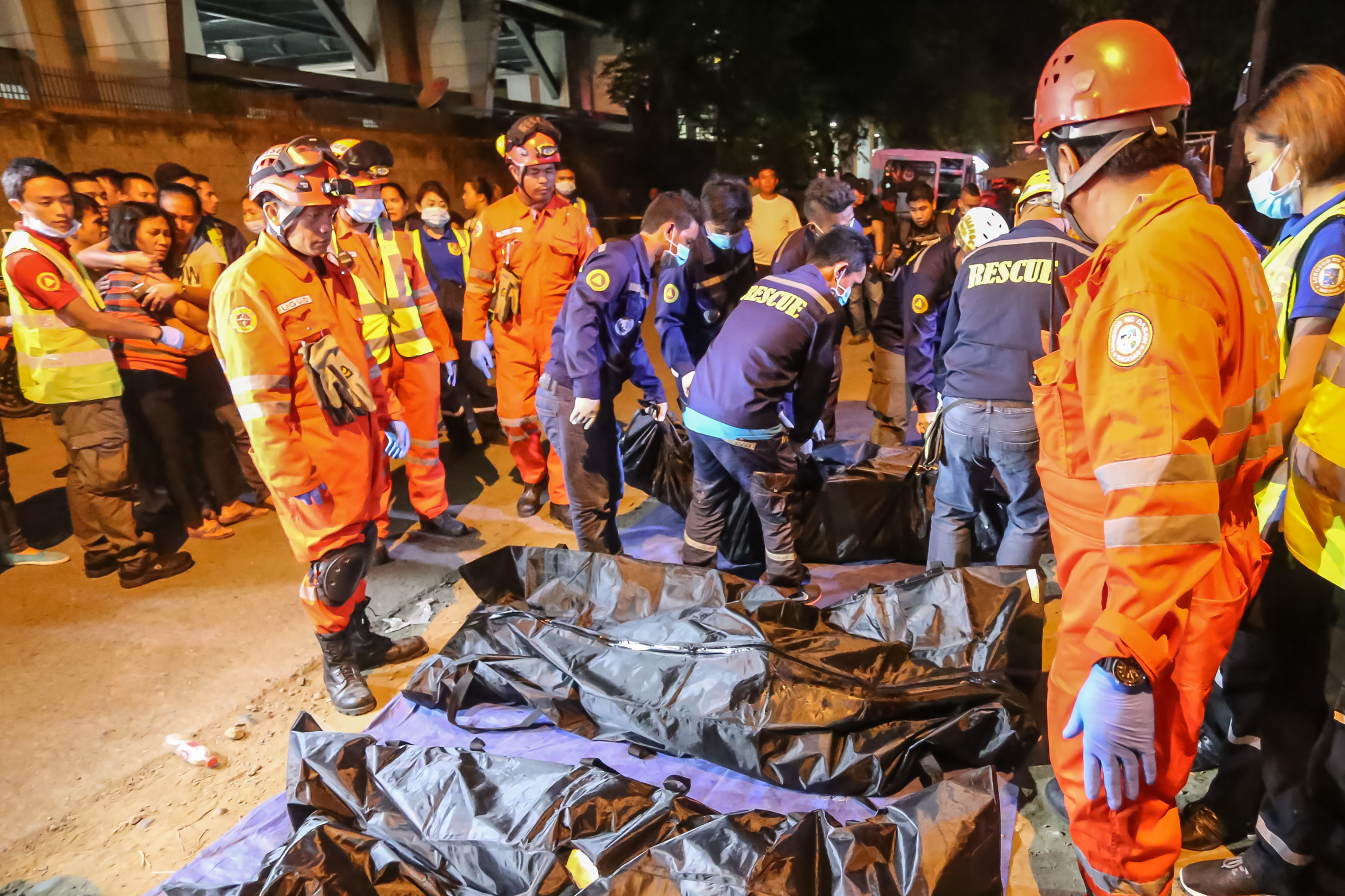 Rescue workers gather bags containing dead bodies of victims of an explosion at a night market in Davao City in southern island of Mindanao early September 3, 2016. Philippine President Rodrigo Duterte branded the bombing of a night market in his home town that killed at least 14 people an act of terrorism, and announced extra powers for the military to combat the threat. / AFP PHOTO / MANMAN DEJETO