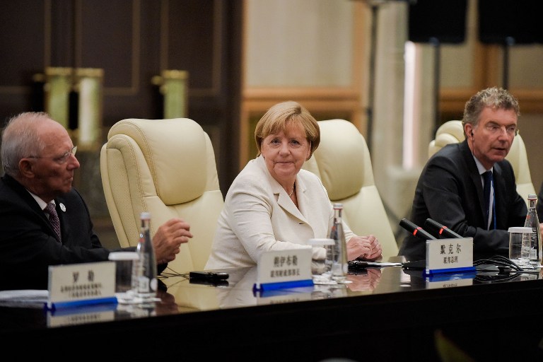 German Chancellor Angela Merkel (C) looks on after her meeting with Chinese President Xi Jinping (not pictured) at their meeting at the West Lake State House in Hangzhou on September 5, 2016. World leaders were gathering in Hangzhou for the 11th G20 Leaders Summit from September 4 to 5. / AFP PHOTO / POOL / Etienne Oliveau