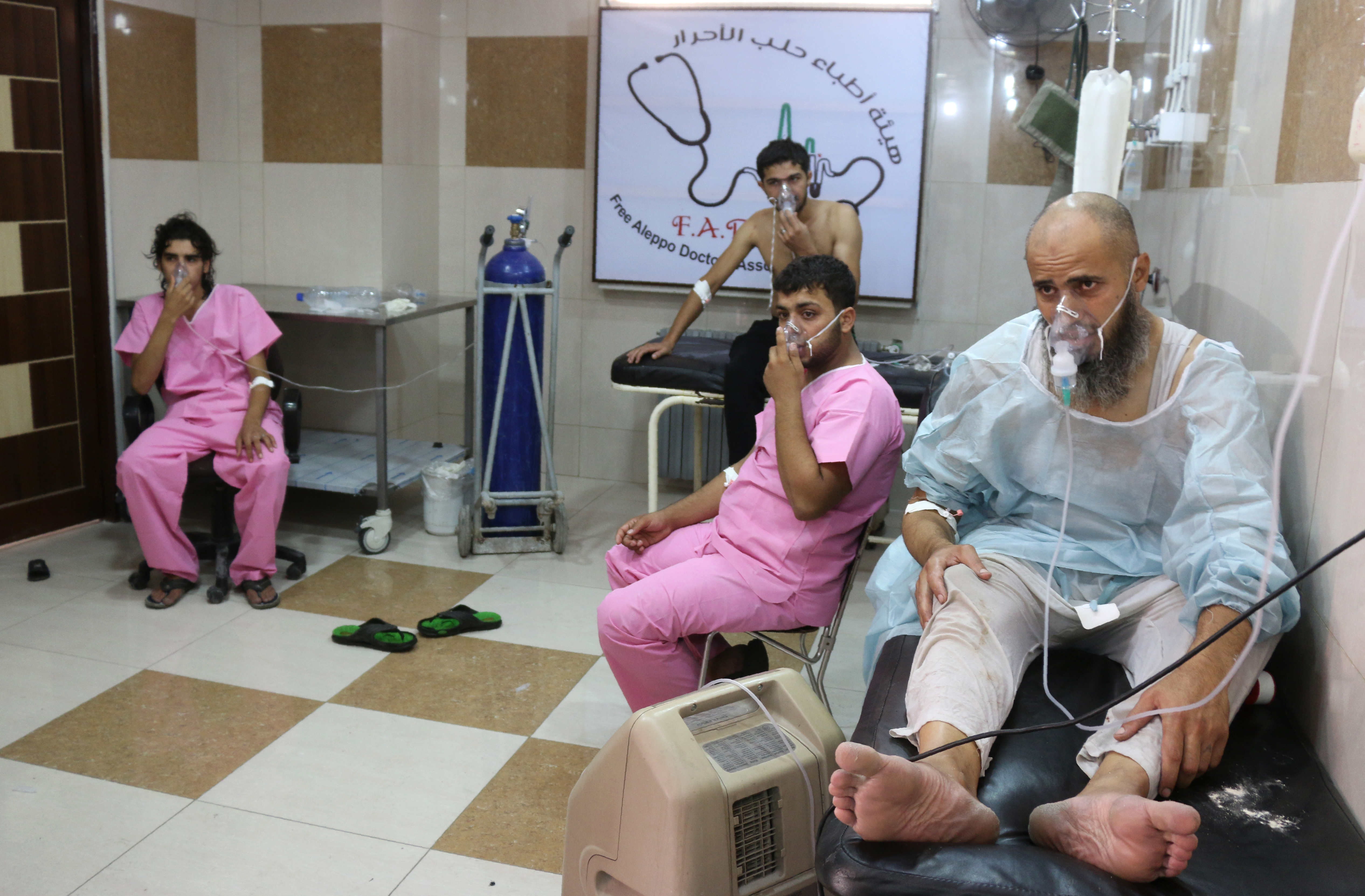 Syrians suffering from breathing difficulties are treated at a make-shift hospital in Aleppo after regime helicopters dropped barrel bombs on the rebel-held Sukkari neighbourhood of the northern Syrian city on September 6, 2016.  The Britain-based Syrian Observatory for Human Rights said the bombs hit the Sukkari neighbourhood and that more than 70 people "most of them civilians" were treated for choking symptoms.  / AFP PHOTO / THAER MOHAMMED