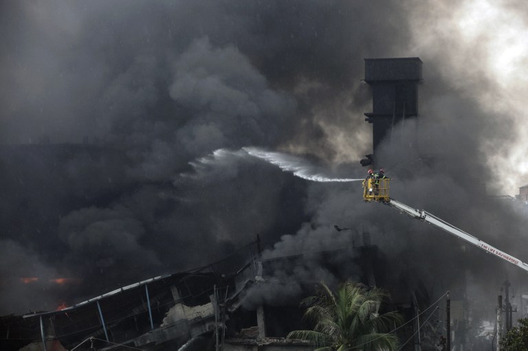 Bangladeshi firefighters work to put out a huge fire at the site of an explosion in a factory in the key Bangladeshi garment manufacturing town of Tongi, just north of the capital Dhaka, on September 10, 2016. At least fifteen people have been killed and 70 injured, many critically, in a huge fire triggered by a boiler explosion at a Bangladeshi packaging factory, officials said on September 10. / AFP PHOTO / Rajib Dhar