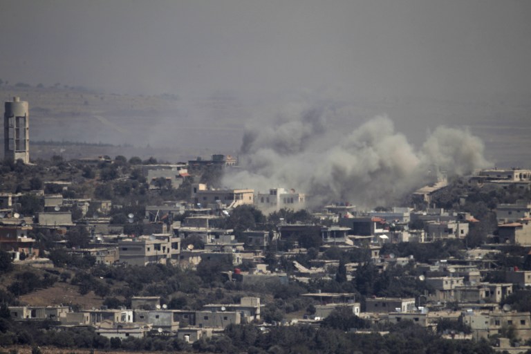 A picture taken from the Israeli-annexed Golan Heights on September 10, 2016 shows smoke rising from the Syrian village of Jubata al-Khashab. Israeli aircraft struck Syrian army positions on September 10 after fire from its war-torn neighbour, Syria, hit the Israeli-held zone of the Golan Heights earlier in the day, the Israeli military said, adding in an army statement that the strike targeted artillery positions of the Syrian regime in response to "a projectile" which hit the northern Golan, causing no injuries or damages. / AFP PHOTO / JALAA MAREY