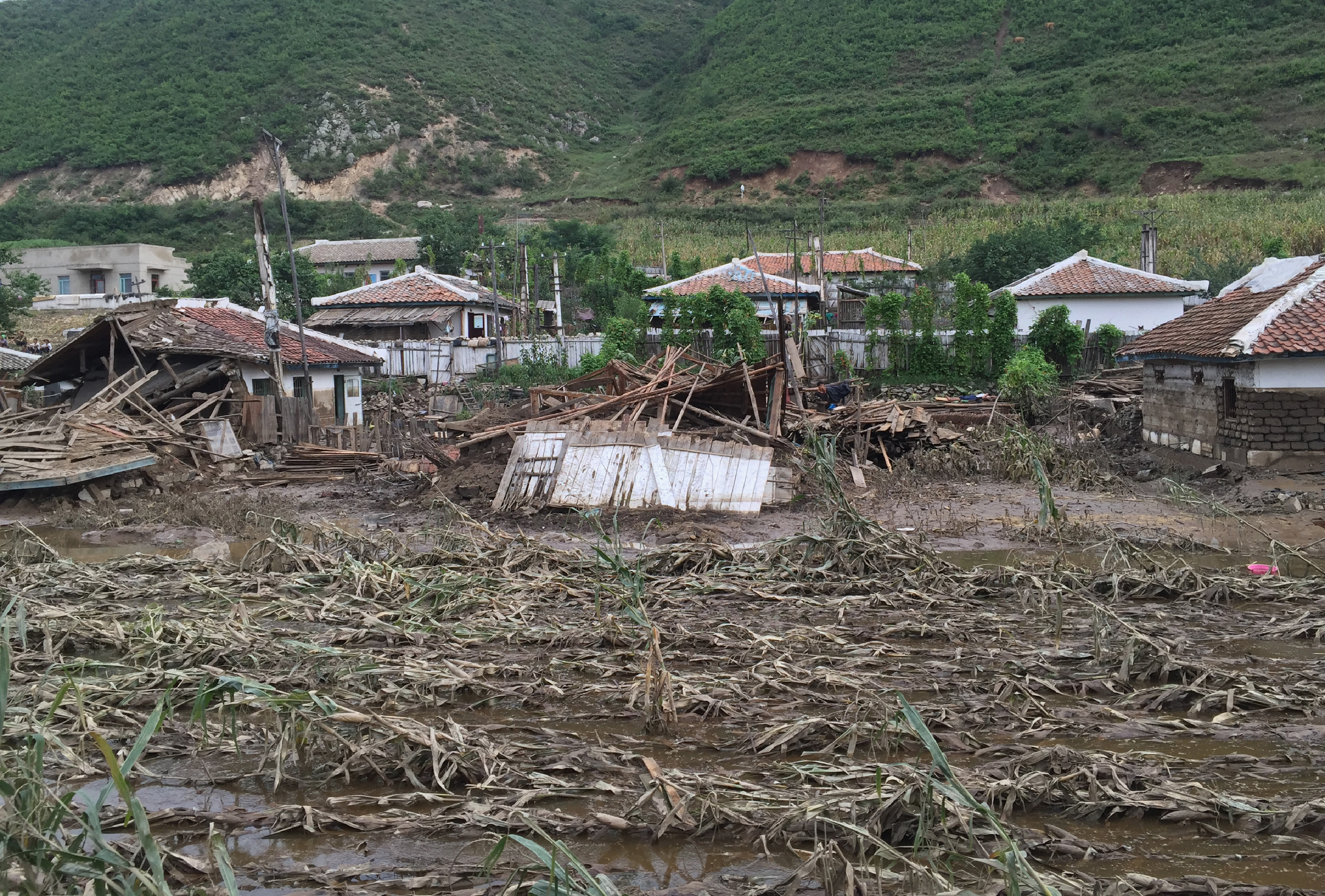 This handout photo taken on September 7, 2016 and released on September 13, 2016 by UNICEF DPRK shows the damage to crops and houses, caused by heavy flooding of the Tumen river along the road from Musan to Yonsa in Hoery?ng, North Hamyong province. Rescue workers struggled to reach North Korea's flood-ravaged communities Tuesday as the Red Cross warned of a "major and complex diaster" which has killed scores and left tens of thousands in urgent need of help. At least 133 people have been killed and hundreds more are still missing after devastating floods hit the country's north, leaving tens of thousands homeless and destitute, with the risk of disease now looming.  / AFP PHOTO / UNICEF DPRK / Murat SAHIN /  - South Korea OUT / REPUBLIC OF KOREA OUT   ---EDITORS NOTE--- RESTRICTED TO EDITORIAL USE - MANDATORY CREDIT "AFP PHOTO/UNICEF DPRK/MURAT SAHIN" - NO MARKETING NO ADVERTISING CAMPAIGNS - DISTRIBUTED AS A SERVICE TO CLIENTS THIS PICTURE WAS MADE AVAILABLE BY A THIRD PARTY. AFP CAN NOT INDEPENDENTLY VERIFY THE AUTHENTICITY, LOCATION, DATE AND CONTENT OF THIS IMAGE. THIS PHOTO IS DISTRIBUTED EXACTLY AS RECEIVED BY AFP.  /