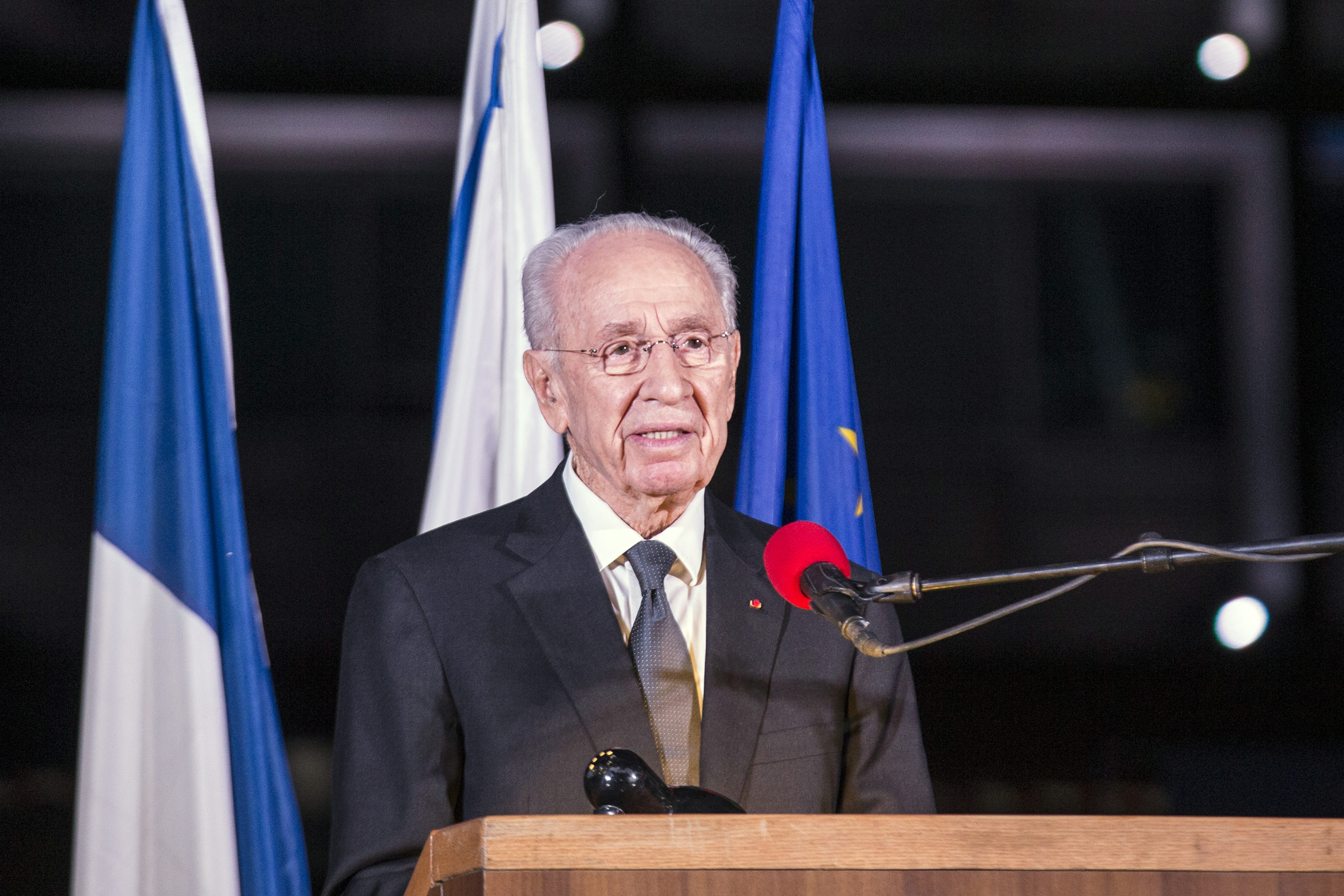 (FILES) This file photo taken on November 14, 2015 shows former Israeli President Shimon Peres delivering a speech in honor of the victims of the Paris attacks in Rabin Square in the Israeli coastal city of Tel Aviv.  Israeli ex-president and Nobel peace laureate Shimon Peres suffered a stroke on September 13, 2016 and was hospitalised, his office said of the 93-year-old. "The ex-president was hospitalised at Tel HaShomer Hospital after a stroke," his office said in a statement. "He is conscious and is receiving appropriate treatment."  / AFP PHOTO / JACK GUEZ