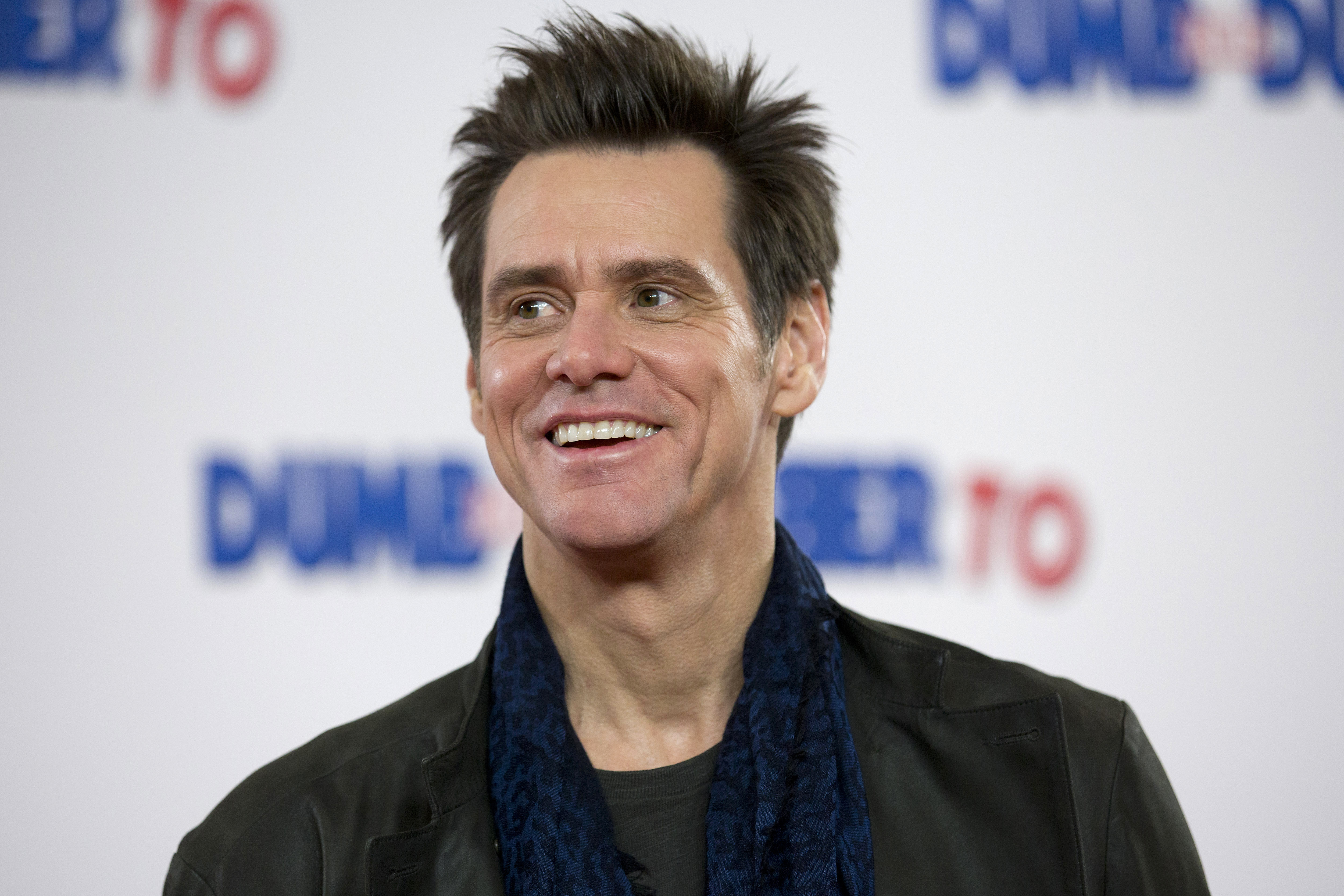 (FILES) This file photo taken on November 20, 2014 shows US actor Jim Carrey poses for photographers at a photocall for the film "Dumb and Dumber To" in London. Veteran comic actor Jim Carrey was sued September 91, 2016 for allegedly procuring drugs under a bogus name for his ex-girlfriend who died of an overdose last year and then trying to hide his involvement. According to the suit filed in Los Angeles Superior Court by Mark Burton, the estranged husband of Carrey's former girlfriend Cathriona White, the actor "used his immense wealth and celebrity status" to obtain opioids for White.  / AFP PHOTO / Justin TALLIS