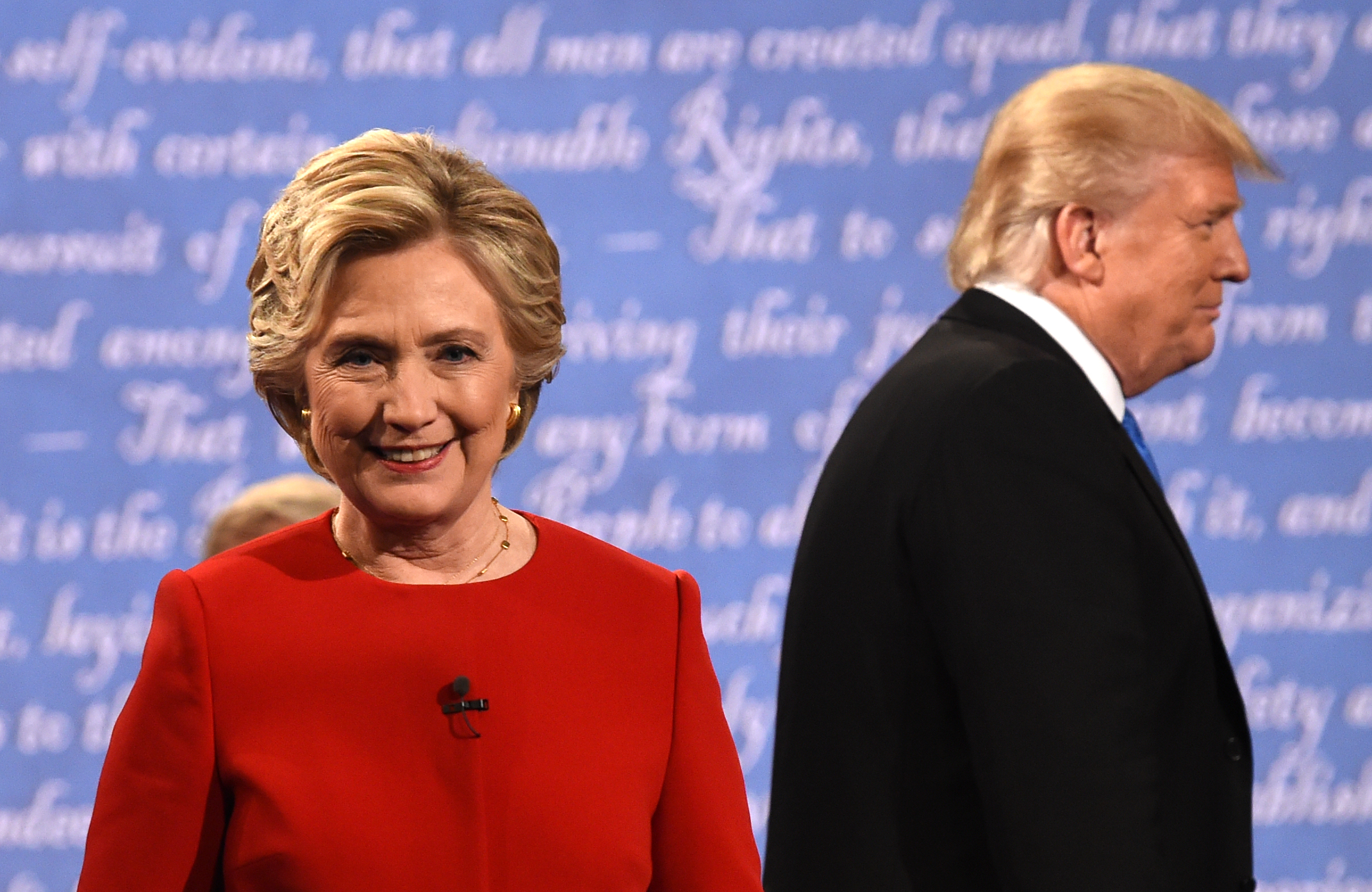 Democratic nominee Hillary Clinton (L) and Republican nominee Donald Trump leave the stage after the first presidential debate at Hofstra University in Hempstead, New York on September 26, 2016. / AFP PHOTO / Timothy A. CLARY