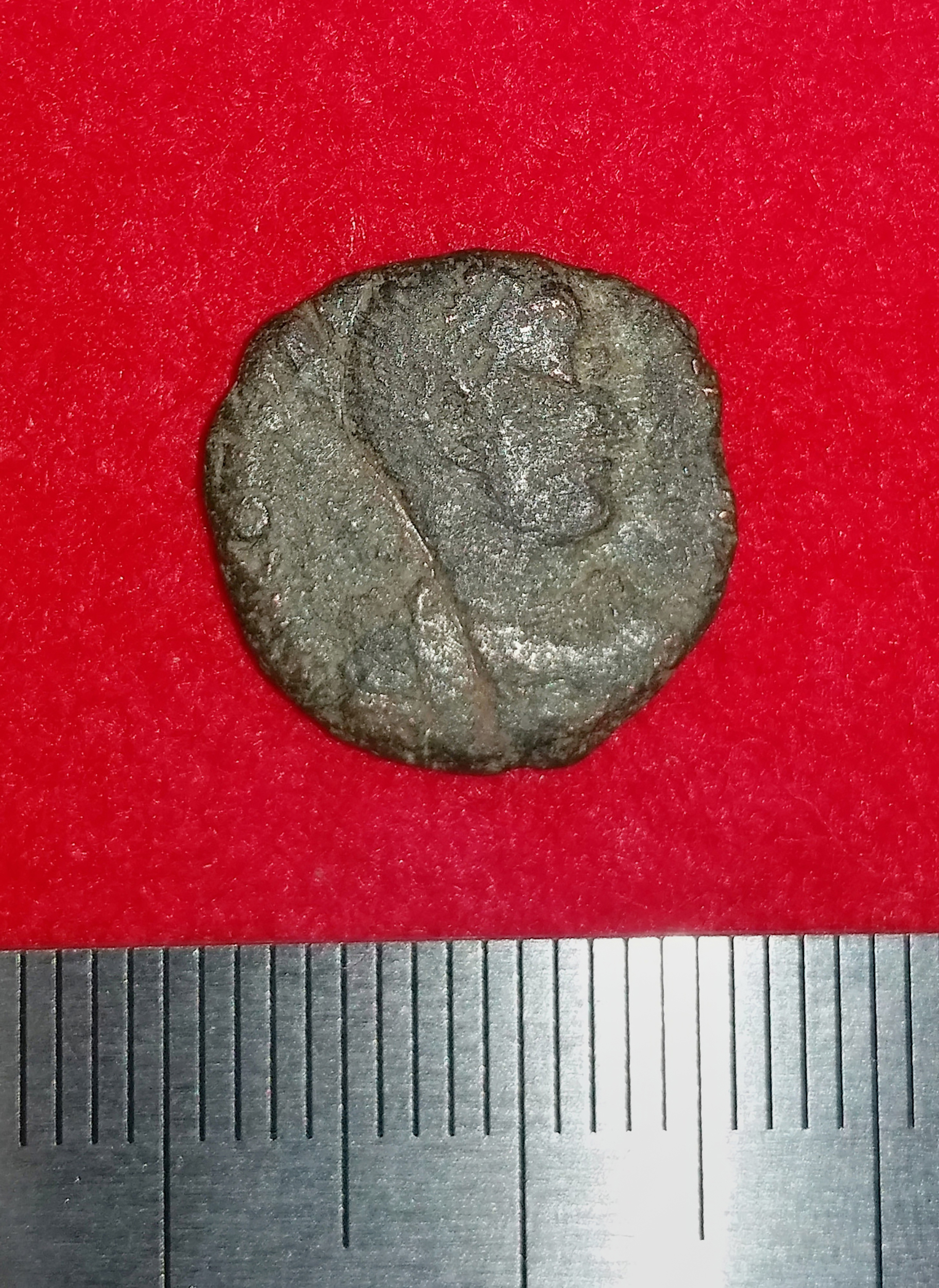This handout photo released on September 26, 2016 by the Uruma city municipal office and received via Jiji Press on September 28 shows a 4th-century copper coin from ancient Rome after it was unearthed in Japan's Okinawa island together with other coins. Japanese archaeologists said on September 28 they have for the first time unearthed ancient Roman coins at the ruins of an old castle. The discovery of 10 bronze and copper coins -- the oldest dating from about 300-400 AD -- in southern Okinawa caught researchers by surprise. A team of researchers have been excavating Katsuren castle in Uruma, which is a UNESCO world heritage site, since 2013. / AFP PHOTO / JIJI PRESS / JIJI PRESS / Japan OUT