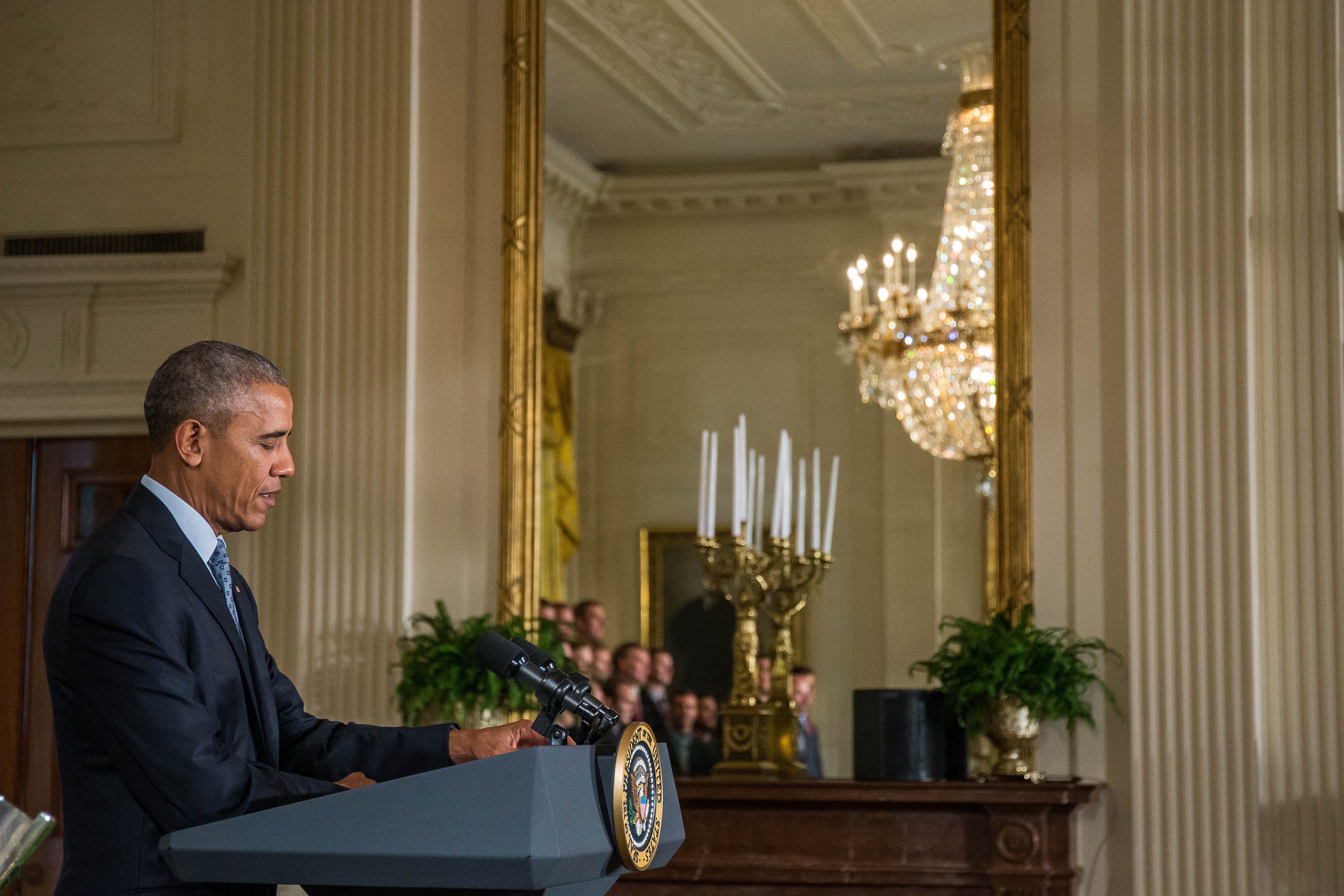 US President Barack Obama speaks during a reception for NASCAR driver Kyle Busch and his team members celebrating Busch's win in the NASCAR Spring Cup Series Championship in the East Room at the White House on September 28, 2016 in Washington, D.C. / AFP PHOTO / ZACH GIBSON