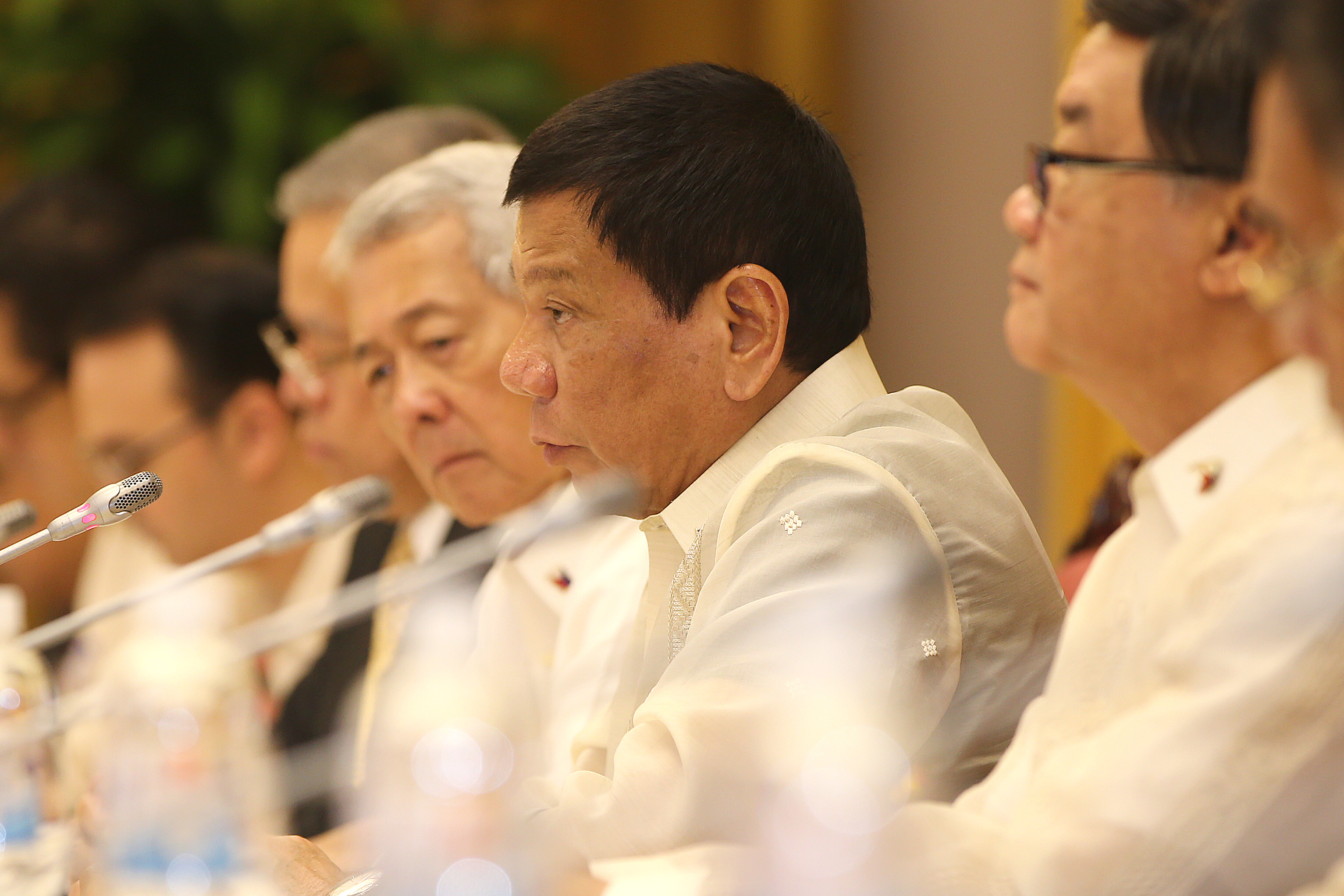 Philippines President Rodrigo Duterte (C) listens to his Vietnamese counterpart Tran Dai Quang (not pictured) during a meeting at the Presidential Palace in Hanoi on September 29, 2016. The Philippine leader is on a two-day visit to Vietnam. / AFP PHOTO / POOL / LUONG THAI LINH