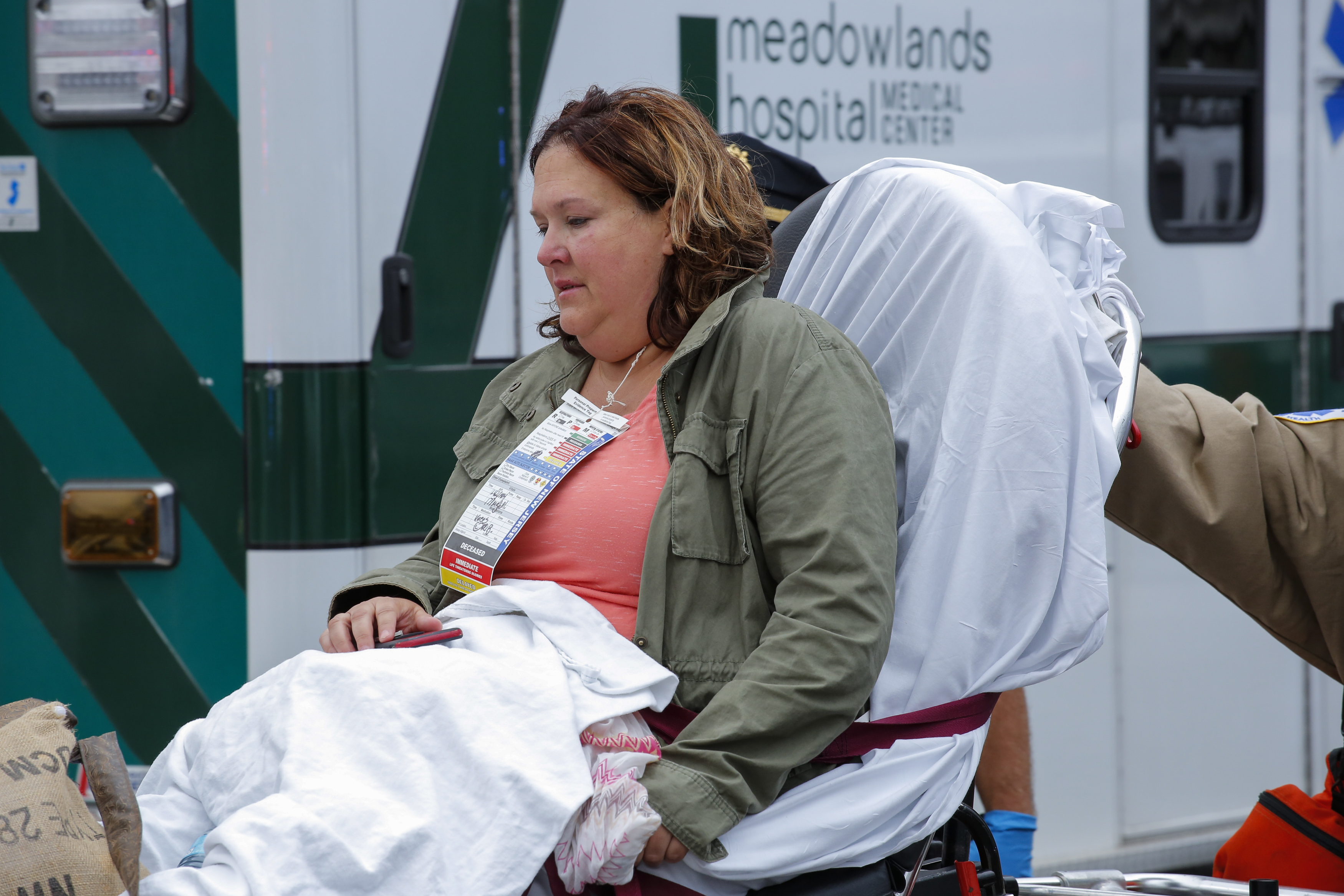 An injured woman is evacuated at New Jersey Transit's rail station in Hoboken, New Jersey September 29, 2016. A packed commuter train crashed into the station in New Jersey during the morning rush hour with one person reported killed and more than 100 injured, many of them in critical condition. The train failed to stop as it pulled into Hoboken station, causing major damage to the transit hub just over the Hudson river from Manhattan. / AFP PHOTO / KENA BETANCUR