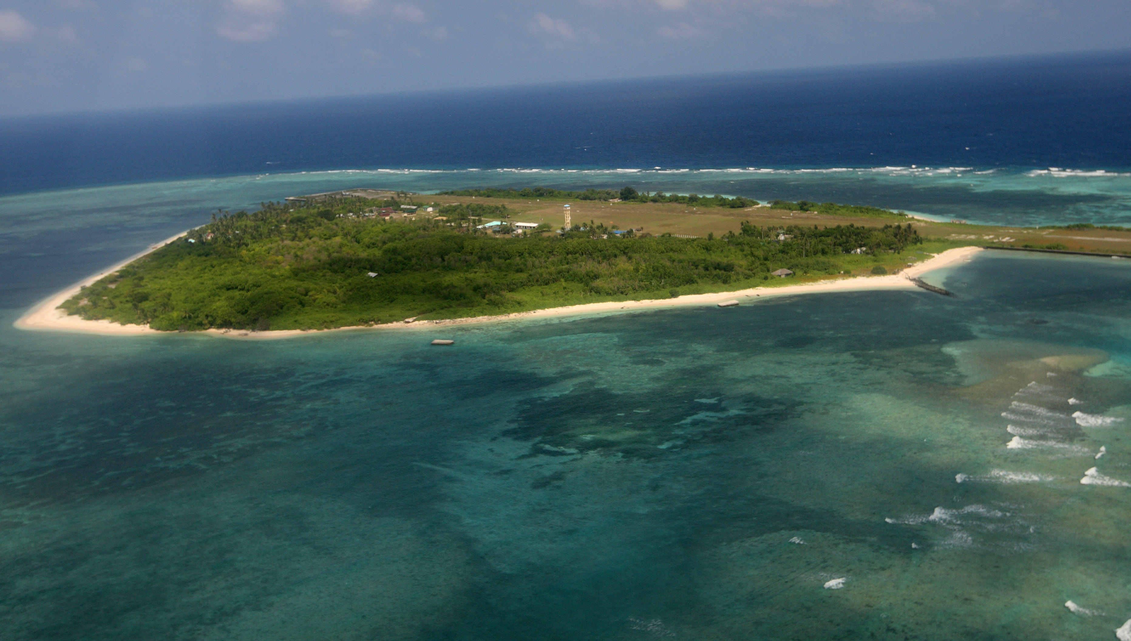 An aerial photo shows Thitu Island, part of the disputed Spratly group of islands, in the South China Sea located off the coast of western Philippines on July 20, 2011.  Philippine lawmakers flew to an island in the disputed Spratly chain, despite warnings from China that the trip would destabilise the region and damage ties.   AFP PHOTO / POOL / AFP PHOTO / POOL / ROLEX DELA PENA
