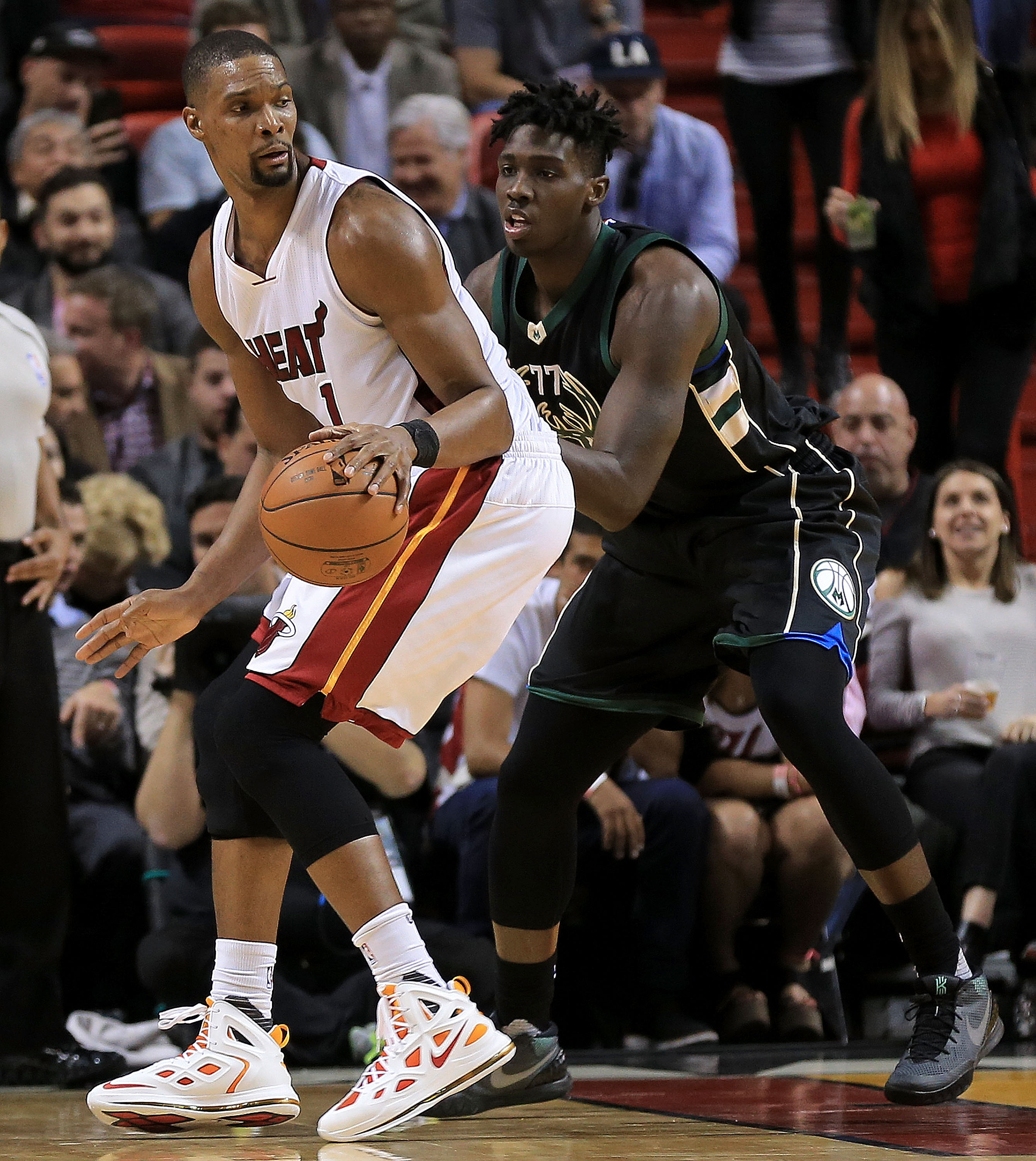 MIAMI, FL - JANUARY 19: Chris Bosh #1 of the Miami Heat shoots over Johnny O'Bryant III #77 of the Milwaukee Bucks during a game at American Airlines Arena on January 19, 2016 in Miami, Florida. NOTE TO USER: User expressly acknowledges and agrees that, by downloading and/or using this photograph, user is consenting to the terms and conditions of the Getty Images License Agreement. Mandatory copyright notice:   Mike Ehrmann/Getty Images/AFP