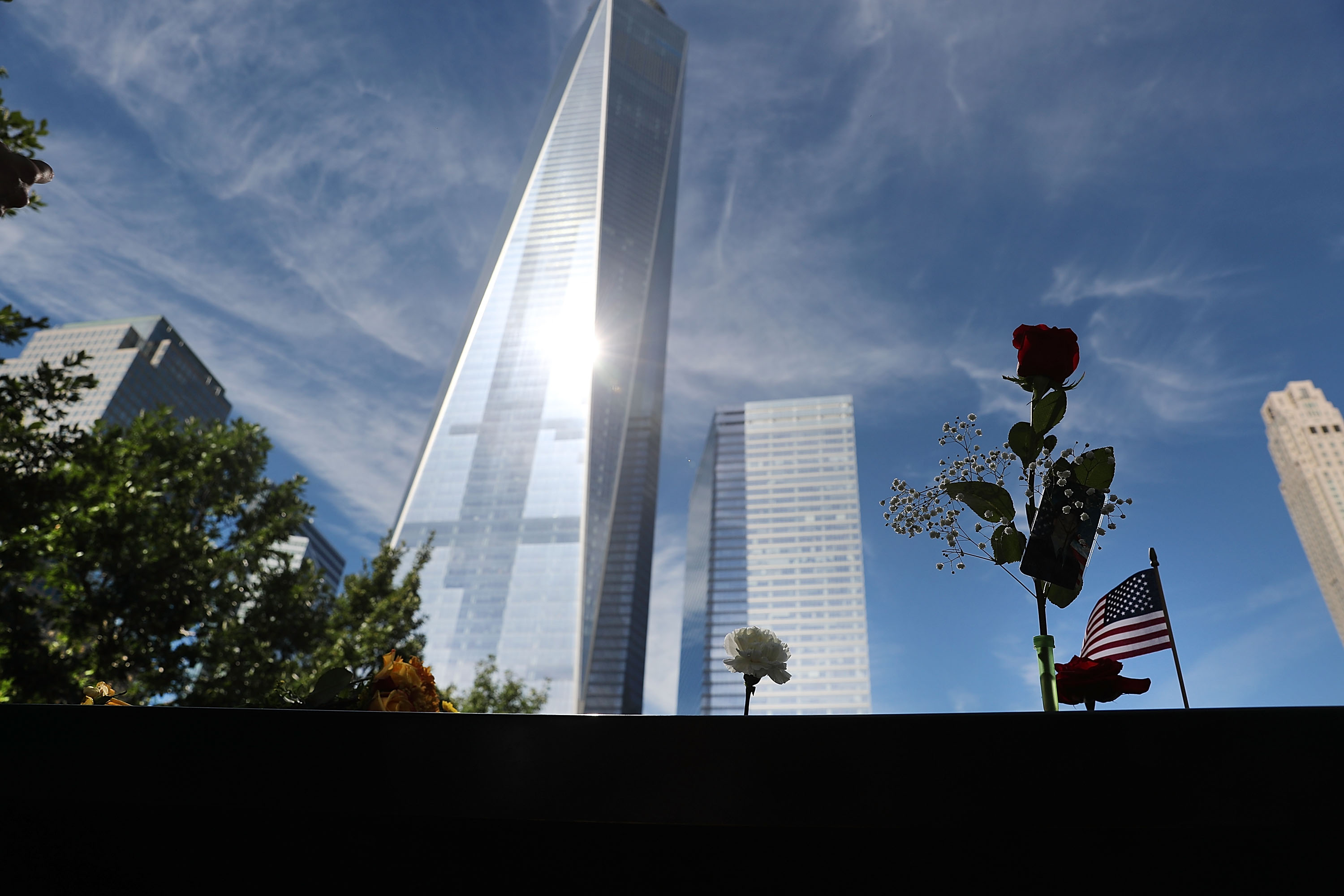 NEW YORK, NY - SEPTEMBER 11: One World Trade towers above one of the pools at the National September 11 Memorial following a morning commemoration ceremony for the victims of the terrorist attacks fifteen years after the day on September 11, 2016 in New York City. Throughout the country services are being held to remember the 2,977 people who were killed in New York, the Pentagon and in a field in rural Pennsylvania. Spencer Platt/Getty Images/AFP