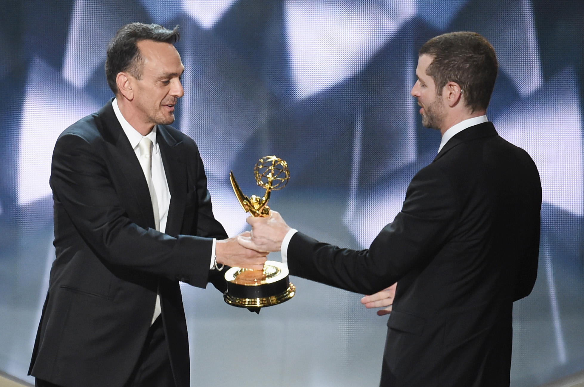 LOS ANGELES, CA - SEPTEMBER 18: Writer/producer D.B. Weiss (R) accepts Outstanding Writing for a Drama Series for 'Game of Thrones' episode 'Battle of the Bastards' from actor Hank Azaria (L) onstage during the 68th Annual Primetime Emmy Awards at Microsoft Theater on September 18, 2016 in Los Angeles, California.   Kevin Winter/Getty Images/AFP