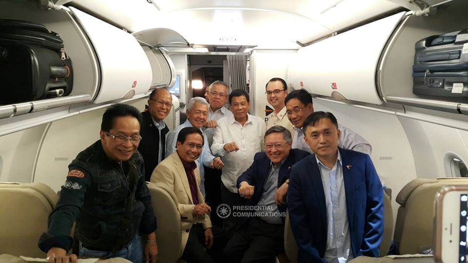 President Rody Duterte shares a light moment with his cabinet members on the flight from Davao to Vientiane for the ASEAN Summit in Lao People’s Democratic Republic  (Photo Courtesy Presidential Communications, Malacanang)