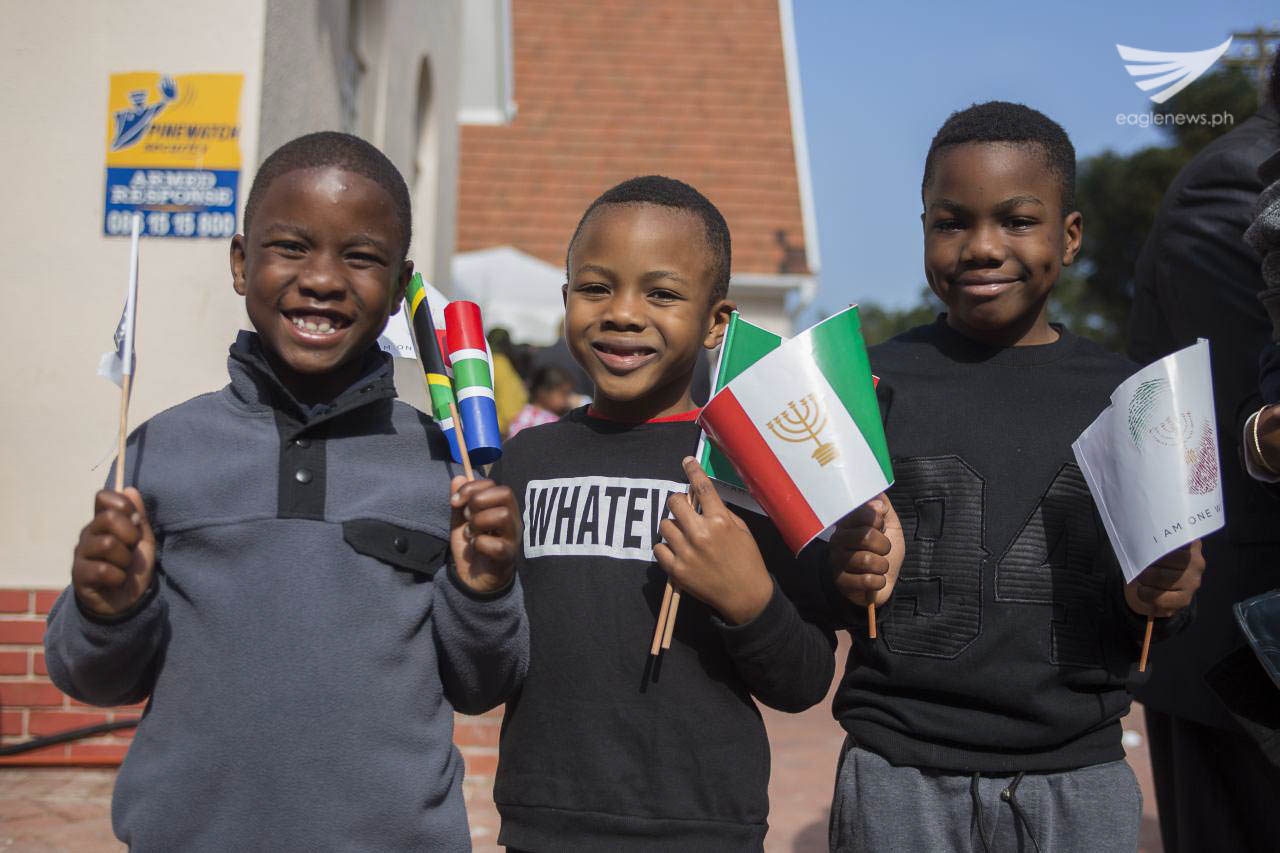 These South African children who are members of the Iglesia Ni Cristo (Church of Christ) are all smiles as they waved flaglets during the dedication of the new INC house of worship in Cape Town, South Africa on August 27, 2016.  INC Executive Minister Brother Eduardo V. Manalo recently dedicated two houses of worship in South Africa.  First was in Johannesburg on August 20, and the second was in Cape Town on August 27.  (Photo courtesy: INC Executive News)