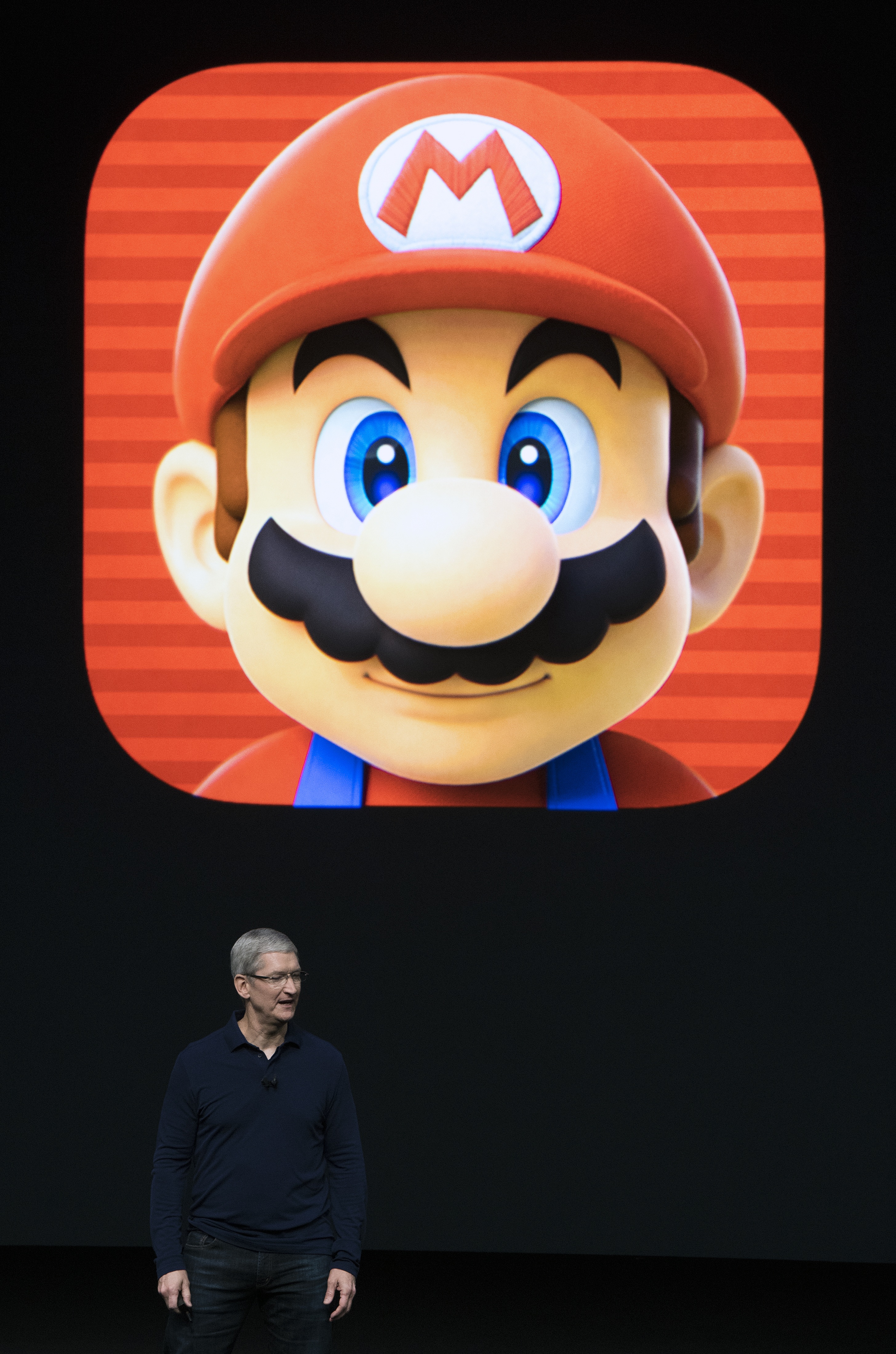 Apple CEO Tim Cook introduces a Super Mario game during an Apple event inside Bill Graham Civic Auditorium in San Francisco, California on September 07, 2016.   Apple is expected to introduce a new iPhone and perhaps a second-generation smartwatch as it polishes its lineup of devices to shine during the year-end shopping season. The rumor mill has been grinding away with talk of iPhone 7 models that will boast faster chips, more sophisticated cameras, and improved software while doing away with jacks for plugging in wired headphones.  / AFP PHOTO / Josh Edelson