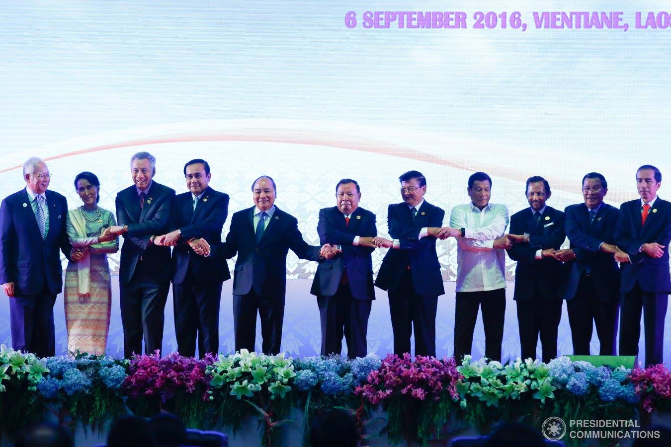 The leaders of the member nations of the ASEAN do the ceremonial ASEAN handshake during the opening of the ASEAN Summit in Laos. (Photo courtesy Presidential Communications, Malacanang)