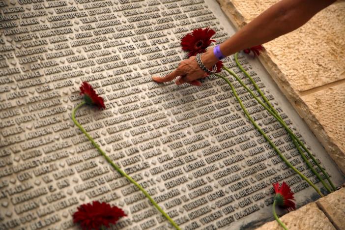A family member of an Israeli victim of the September 11th attacks, points to the victim's name, engraved on a monument, during a memorial event marking the 15th anniversary of September 11, 2001 attacks in the U.S., at the 9/11 Living Memorial Plaza in Jerusalem September 11, 2016. REUTERS/Ronen Zvulun