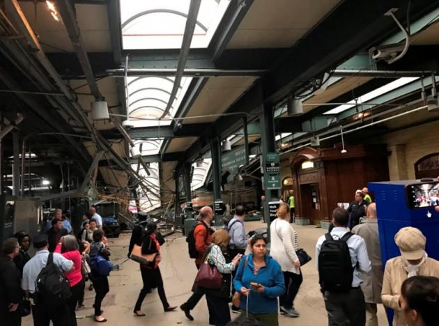 Onlookers view a New Jersey Transit train that derailed and crashed through the station in Hoboken, New Jersey, U.S. in this picture courtesy of David Richman taken September 29, 2016. Courtesy of David Richman via REUTERS