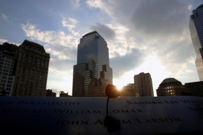 The sun peeks out over a rose that is placed on a name on the memorial at the National September 11 Memorial and Museum in Lower Manhattan in New York City, U.S., September 9, 2016. REUTERS/Brendan McDermid