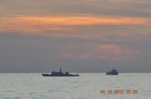A handout photo shows two Chinese surveillance ships which sailed between a Philippines warship and eight Chinese fishing boats to prevent the arrest of any fishermen in the Scarborough Shoal, a small group of rocky formations whose sovereignty is contested by the Philippines and China, in the South China Sea, about 124 nautical miles off the main island of Luzon April 10, 2012. REUTERS/Philippine Army Handout