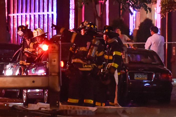 New York City firefighters stand near the site of an explosion in the Chelsea neighborhood of Manhattan, New York, U.S. September 17, 2016. REUTERS/Rashid Umar Abbasi