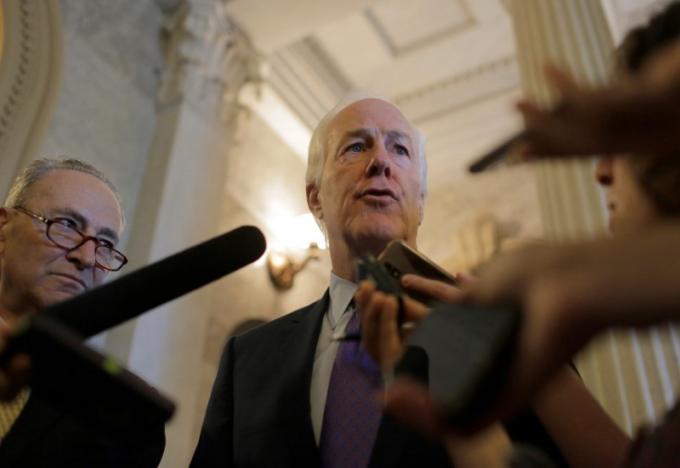 Senators Chuck Schumer (D-NY) (L) watches as John Cornyn (R-TX) speaks after the Senate voted to override U.S. President Barack Obama's veto of a bill that would allow lawsuits against Saudi Arabia's government over the Sept. 11 attacks, on Capitol Hill in Washington, U.S., September 28, 2016. REUTERS/Joshua Roberts