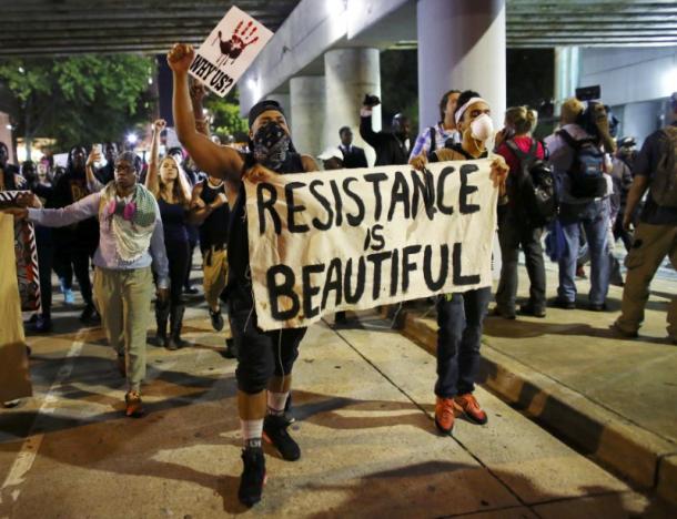 Protesters walk in the streets downtown during another night of protests over the police shooting of Keith Scott in Charlotte, North Carolina, U.S. September 22, 2016.  REUTERS/Mike Blake