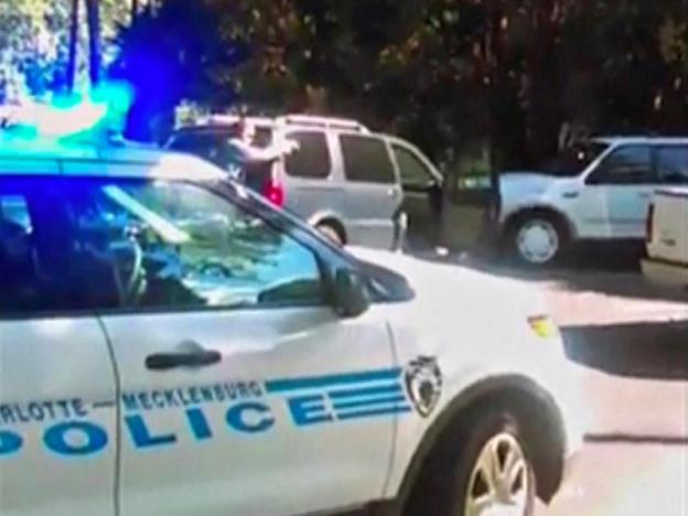 A police officer points his gun at Keith Scott in Charlotte, North Carolina, U.S. in this still image taken from video, received by Reuters, September 23, 2016. Courtesy of the Scott family/Handout via Reuters