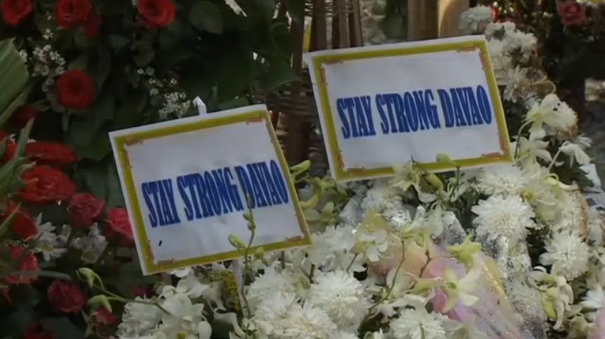 Two framed posters with the words, "Stay strong Davao" are placed amidst the floral tributes at the blast site.  (Photo grabbed from Reuters video/Courtesy Reuters) 