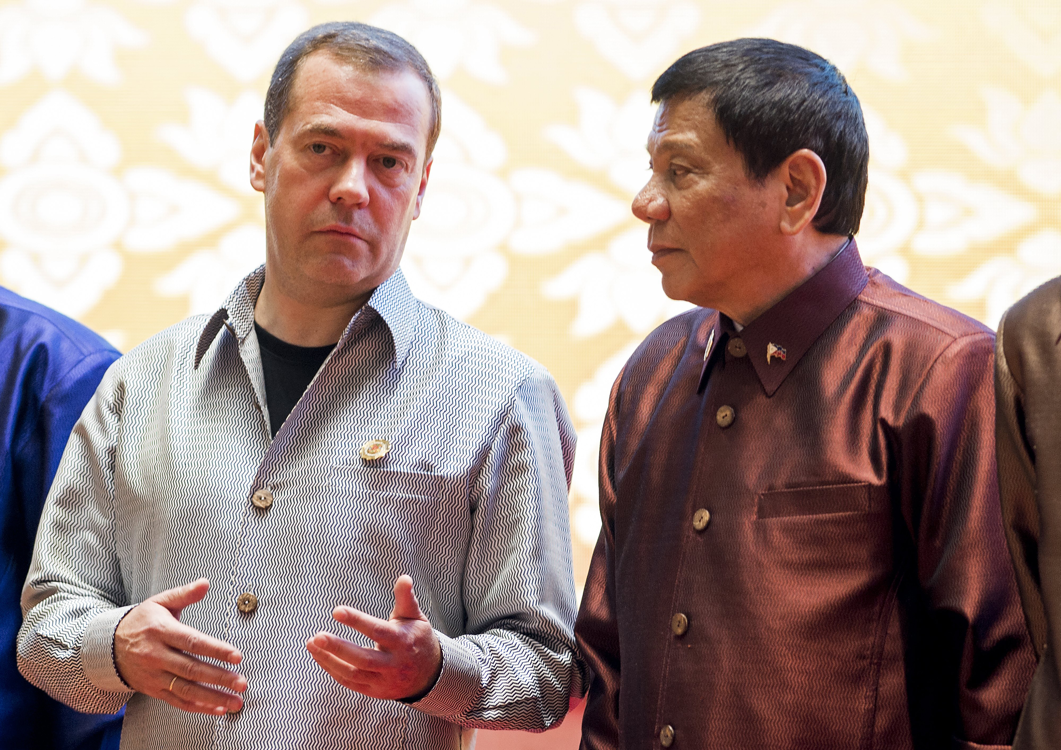Russian Prime Minister Dmitry Medvedev (L) chats with Philippine President Rodrigo Duterte as they attend the gala dinner during the second day of the Association of Southeast Asian Nations (ASEAN) Summit in Vientiane on September 7, 2016. The gathering will see the 10 ASEAN members meet by themselves, then with leaders from the US, Japan, South Korea and China. / AFP PHOTO / YE AUNG THU