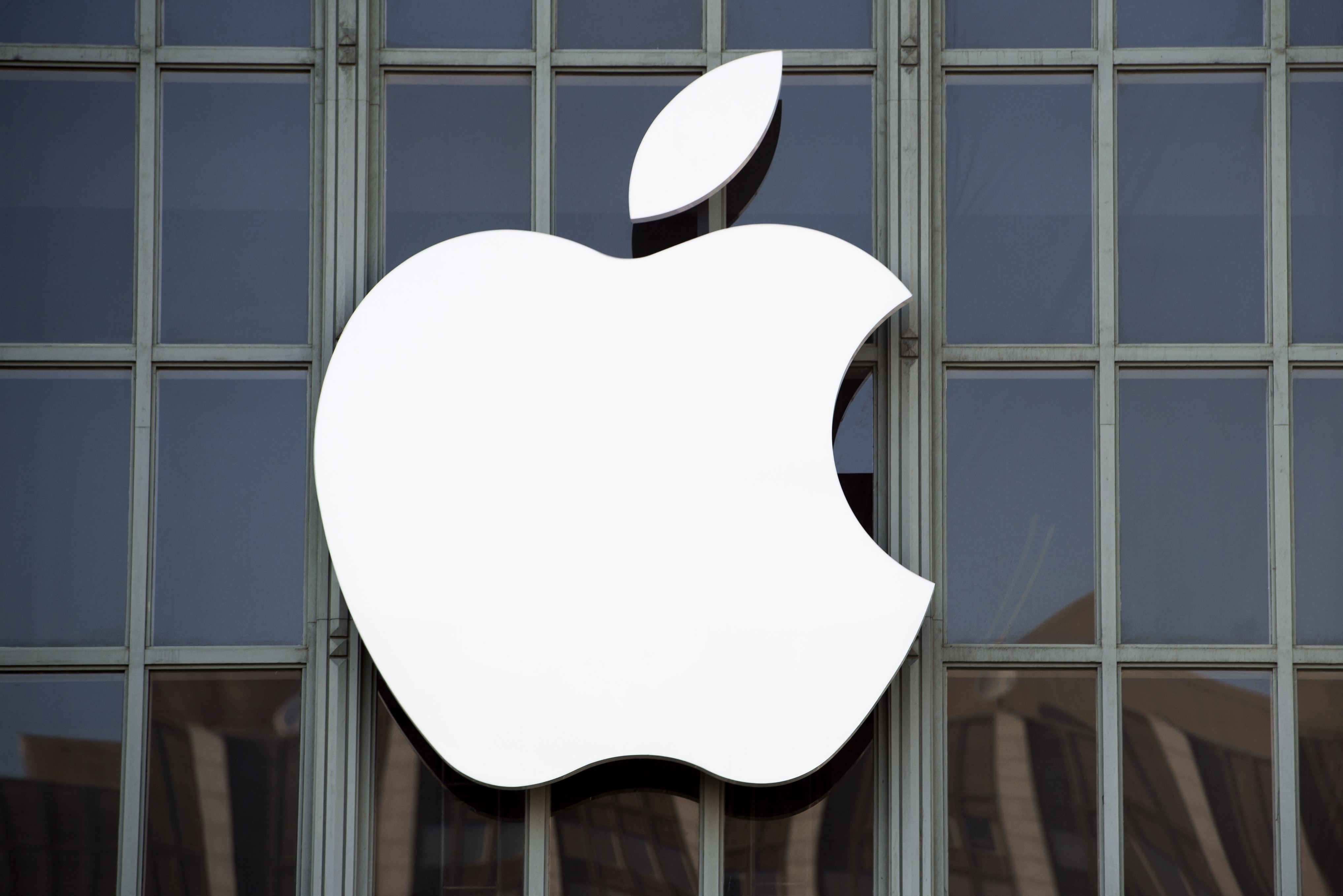 The Apple logo is seen on the outside of Bill Graham Civic Auditorium before the start of an event in San Francisco, California on September 7, 2016. Apple on Wednesday is expected to introduce a new iPhone and perhaps a second-generation smartwatch as it polishes its lineup of devices to shine during the year-end shopping season. The rumor mill has been grinding away with talk of iPhone 7 models that will boast faster chips, more sophisticated cameras, and improved software while doing away with jacks for plugging in wired headphones.  / AFP PHOTO / Josh Edelson