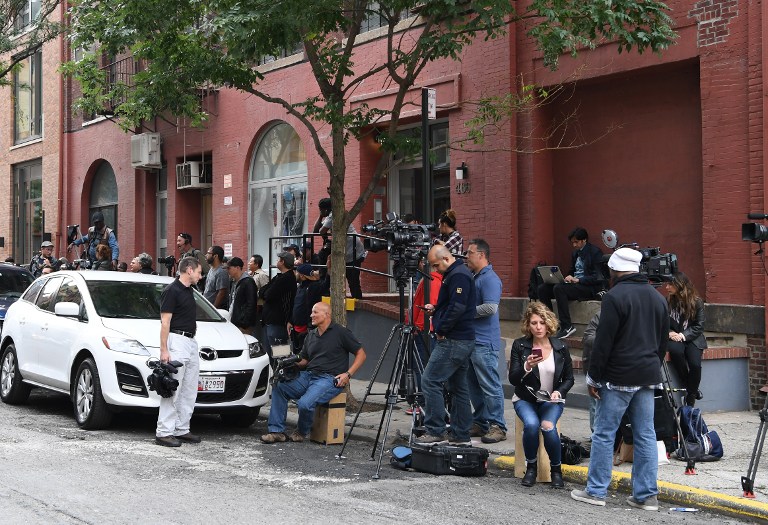 Media gathers across the street of Kim Kardashian and Kanye West's town house in New York City October 3, 2016. Kardashian, a US reality television star, was tied up and robbed at gunpoint earlier on Monday at a luxury Paris residence by robbers who made off with millions in jewellery. She flew out of France on a private jet on Monday after being questioned by police about the robbery. Kardashian, one of the most recognisable US celebrities, had made a series of high-profile appearances at Paris fashion week. / AFP PHOTO / Angela Weiss