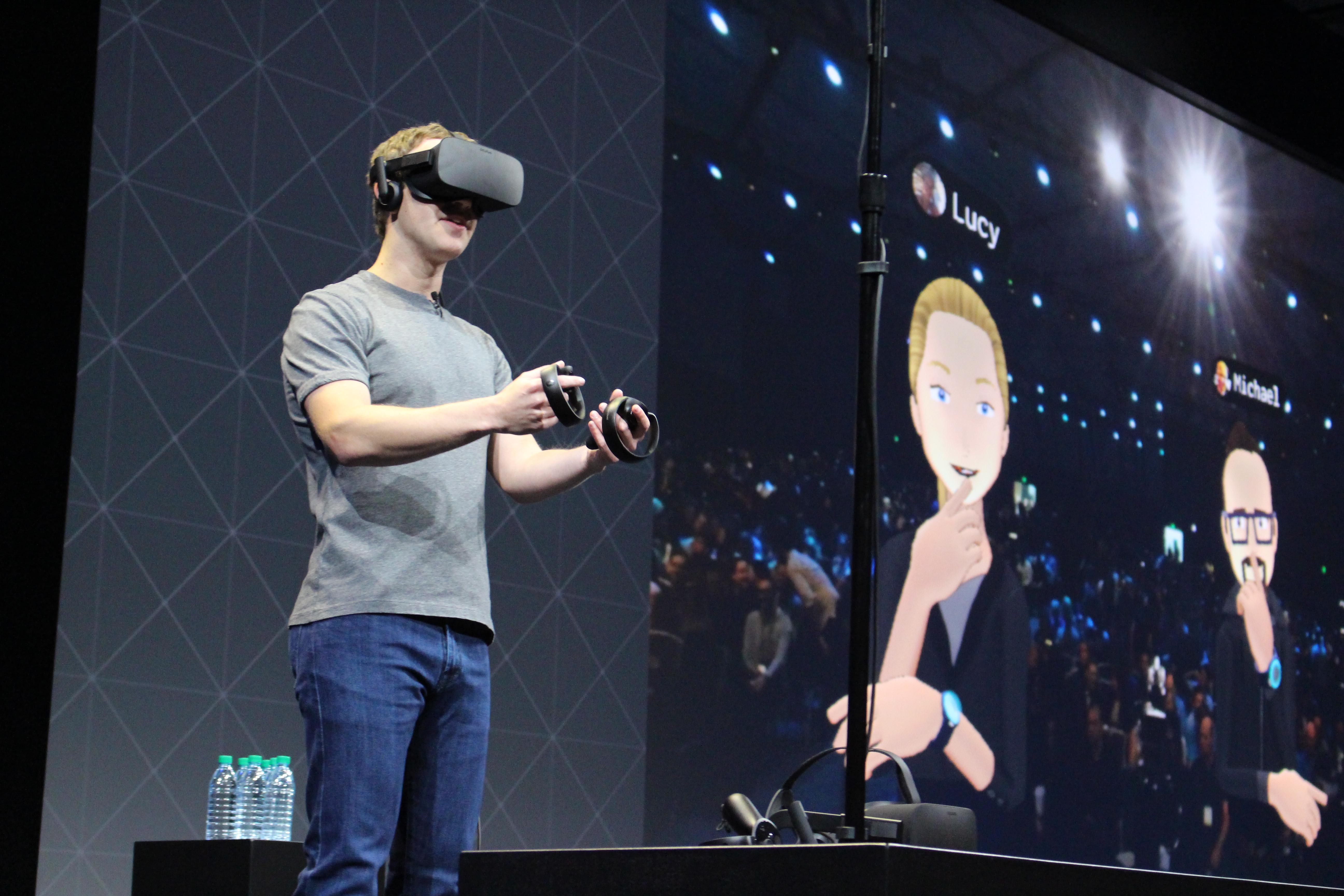 Facebook co-founder and chief executive, Mark Zuckerberg, speaks at an Oculus developers conference while wearing a virtual reality headset in San Jose, California on October 6, 2016. Facebook unveiled new hardware for its Oculus division as part of a stepped-up effort to integrate virtual reality with the leading social network. The new offerings aim to get an array of virtual reality gear to consumers in the coming months, including a new "Touch" controller and compatible computer to help spur Facebook's push. / AFP PHOTO / Glenn CHAPMAN
