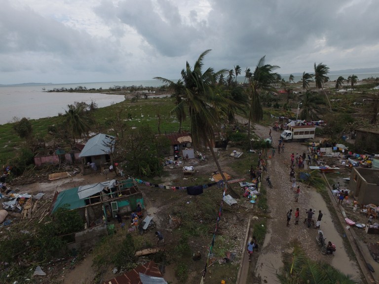 An ariel view shows damaged houses are after the passing of Hurricane Matthew, in Sous Roche in Les Cayes, Southwest Haiti, on October 6, 2016. The storm killed at least 108 people in Haiti, the poorest country in the Americas, with the final toll expected to be much higher. / AFP PHOTO / Nicolas GARCIA