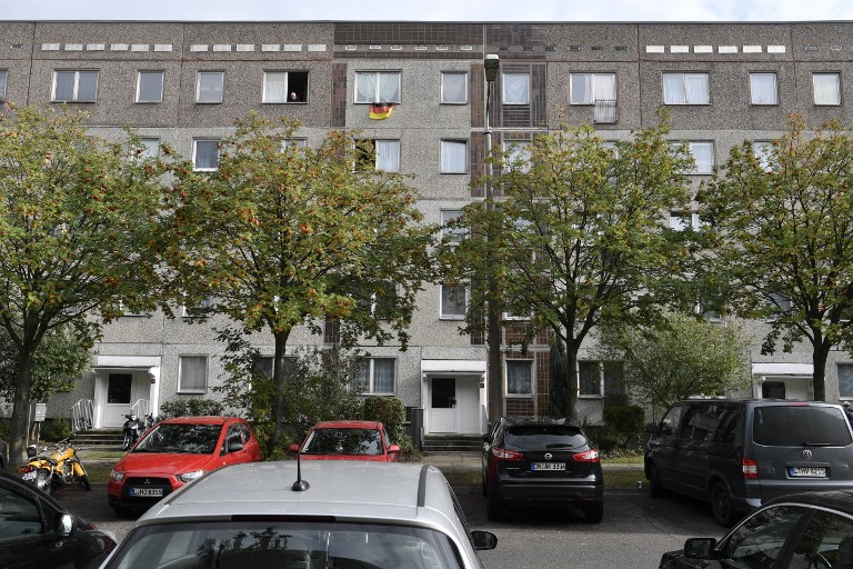 This picture shows the flat (Up Center R) on the last floor of a communist-era housing block in Leipzig Paunsdorf, eastern Germany, where a Syrian man, suspected of plotting a jihadist bomb attack, has been arrested on October 10, 2016. The Syrian man was arrested with the help of two of the fugitive's compatriots, in a case that sparked fresh calls for greater checks on asylum seekers. / AFP PHOTO / John MACDOUGALL