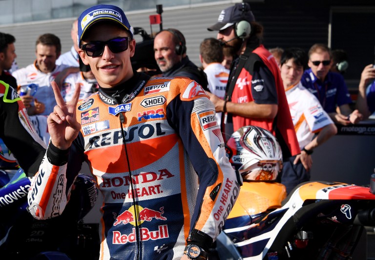Repsol Honda Team's Spanish rider Marc Marquez gestures at the parc ferme after the qualifying session at the Japanese Grand Prix in the Twin Ring Motegi circuit in Motegi on October 15, 2016. / AFP PHOTO / TOSHIFUMI KITAMURA