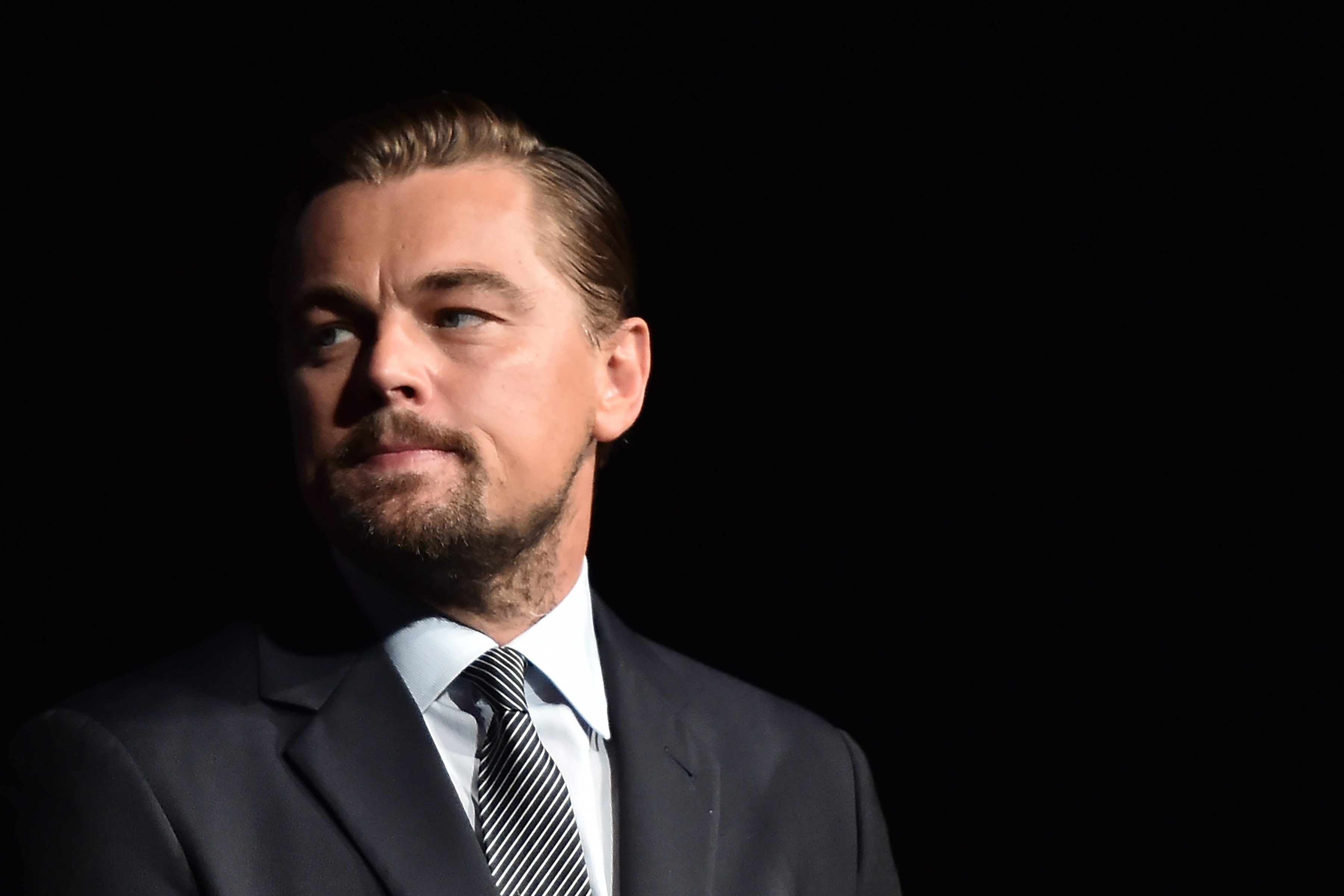 US actor Leonardo DiCaprio looks on prior to speaking on stage during the Paris premiere of the documentary film "Before the Flood" on October 17, 2016 at the Theatre du Chatelet in Paris.  US actor Leonardo DiCaprio has issued an impassioned call for immediate action on climate change in "Before the Flood", a documentary film making its premiere in Paris on October 17. DiCaprio takes viewers around the world to meet experts and politicians in order to reveal the scale of the problem, its effects and the paths towards solutions.  / AFP PHOTO / POOL / CHRISTOPHE ARCHAMBAULT