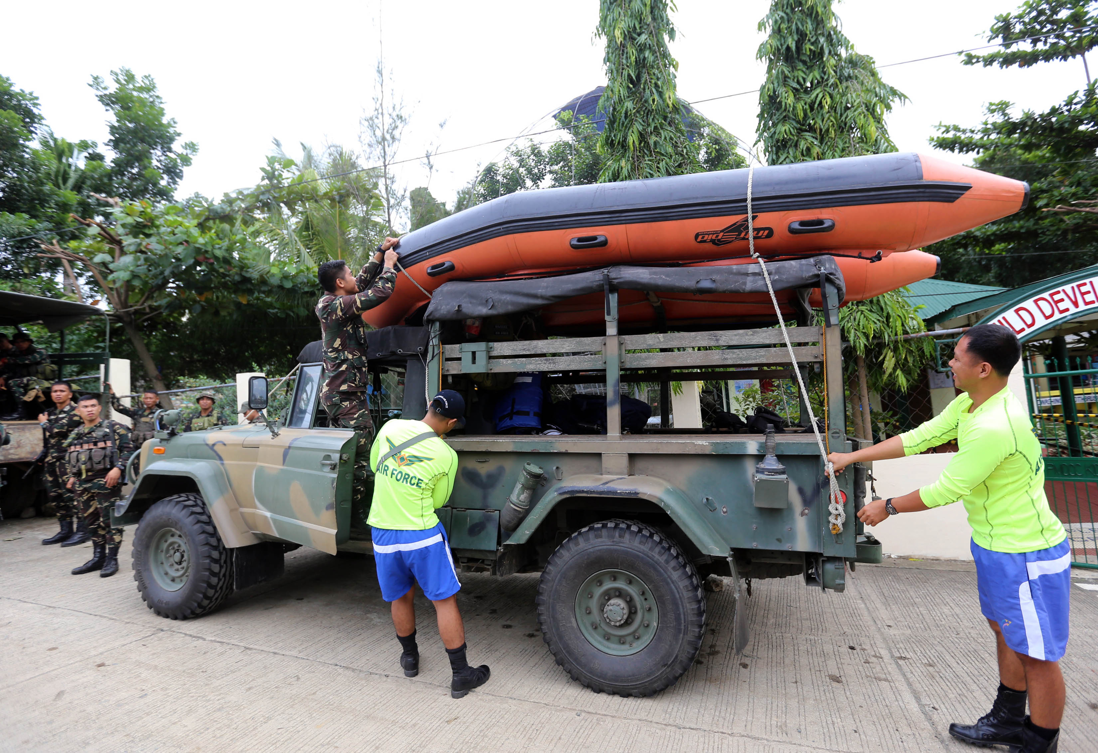 Rescuers load a rubber boat onto their vehicle as they prepare for Typhoon Haima in Ilagan town, Isabela province on October 19, 2016. Millions of people in the Philippines were ordered on October 19 to prepare for one of the strongest typhoons to ever hit the disaster-battered country, with authorities warning of giant storm surges and destructive winds. / AFP PHOTO / STR