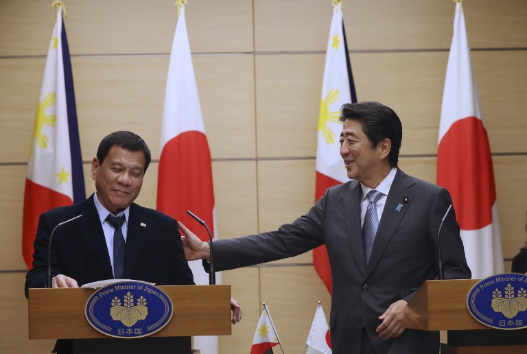 Philippine President Rodrigo Duterte and Japan's Prime Minister Shinzo Abe (R) attend a joint press conference at the prime minister's office in Tokyo on October 26, 2016. / AFP PHOTO / AP POOL / Eugene Hoshiko