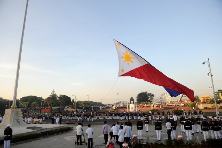 (File photo) The Philippines national flag is raised during a wreath-laying ceremony on the 106th anniversary of Philippine national hero Jose Rizal at the Luneta Park in Manila on December 30, 2012. Rizal was sentenced to death by a firing squad of the Spanish army after he was accused of leading a revolution against Spain. AFP PHOTO NOEL CELIS 