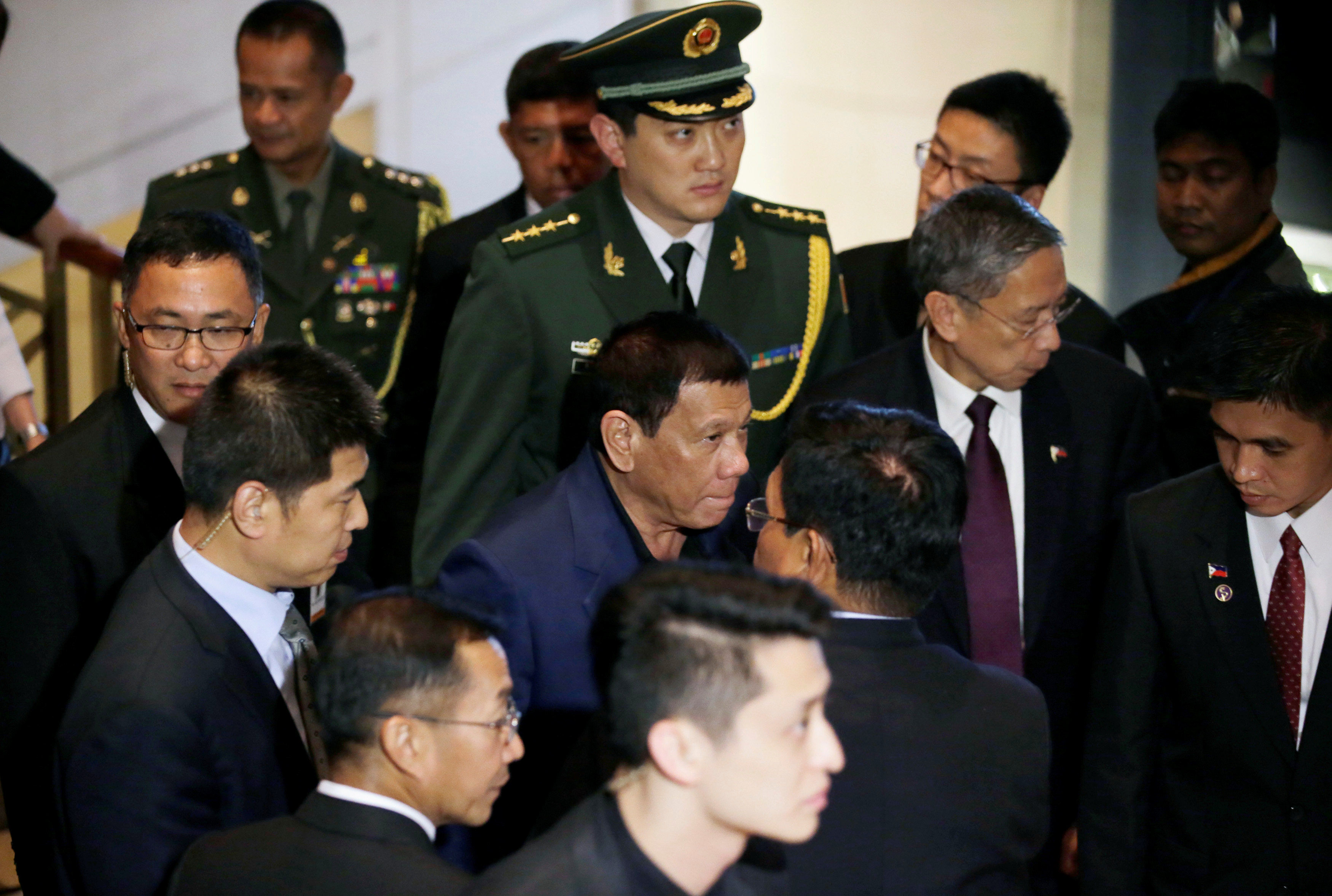 Philippines' President Rodrigo Duterte (C) leaves a hotel in Beijing, China, October 21, 2016. REUTERS/Jason Lee