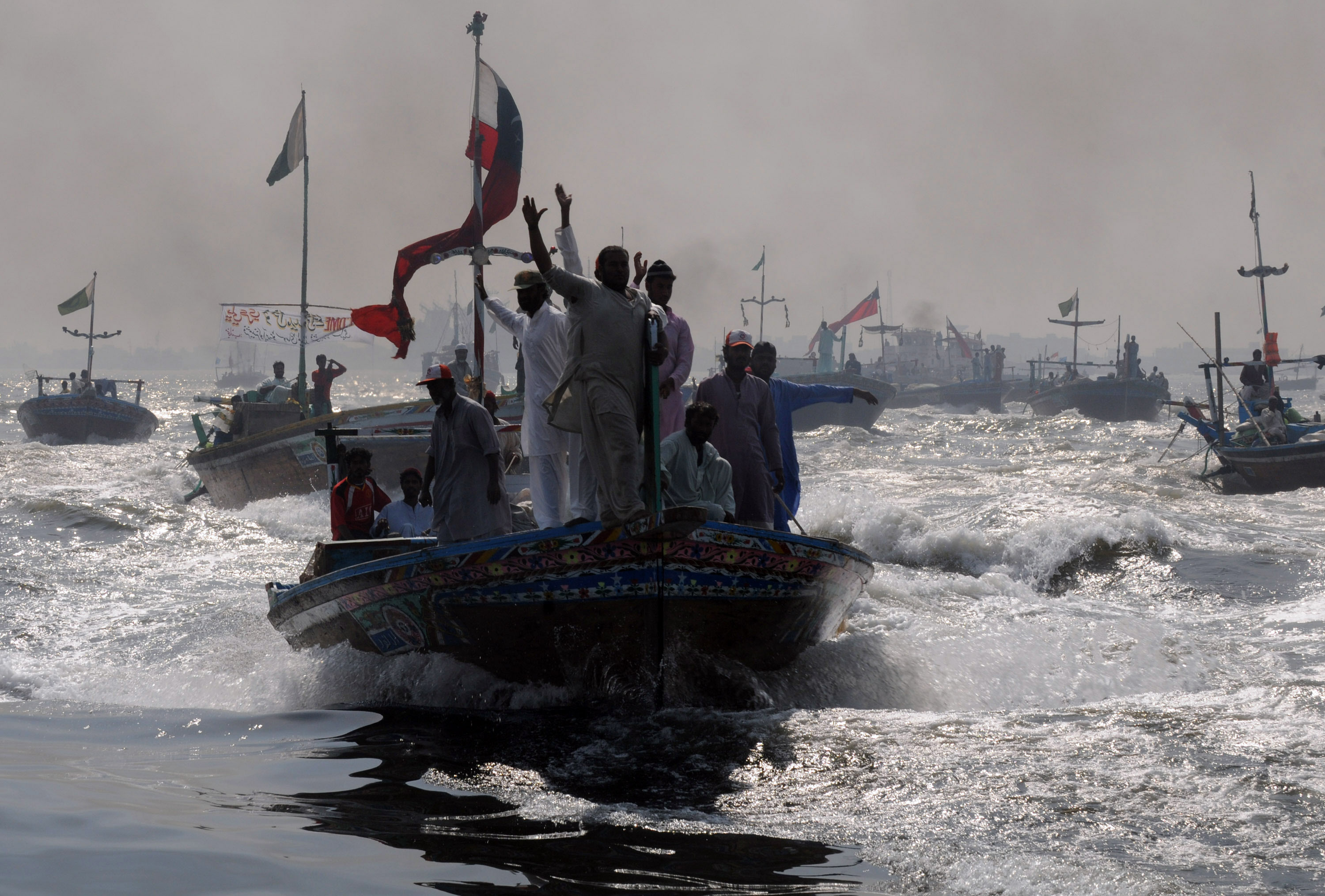 Pakistani fishing boats rally in the Arabian Sea ahead of the World Fisheries Day in Karachi on November 20, 2009. Fishing communities worldwide celebrate on November 21 withrallies, workshops, public meetings, cultural programs, dramas, exhibition, music show, and demonstrations to highlight the importance of maintaining the world's fisheries. A recent United Nations study reported that more than two-thirds of the world's fisheries have been overfished or are fully harvested and more than one third are in a state of decline because of factors such as the loss of essential fish habitats, pollution, and global warming. AFP PHOTO/ RIZWAN TABASSUM / AFP PHOTO / RIZWAN TABASSUM