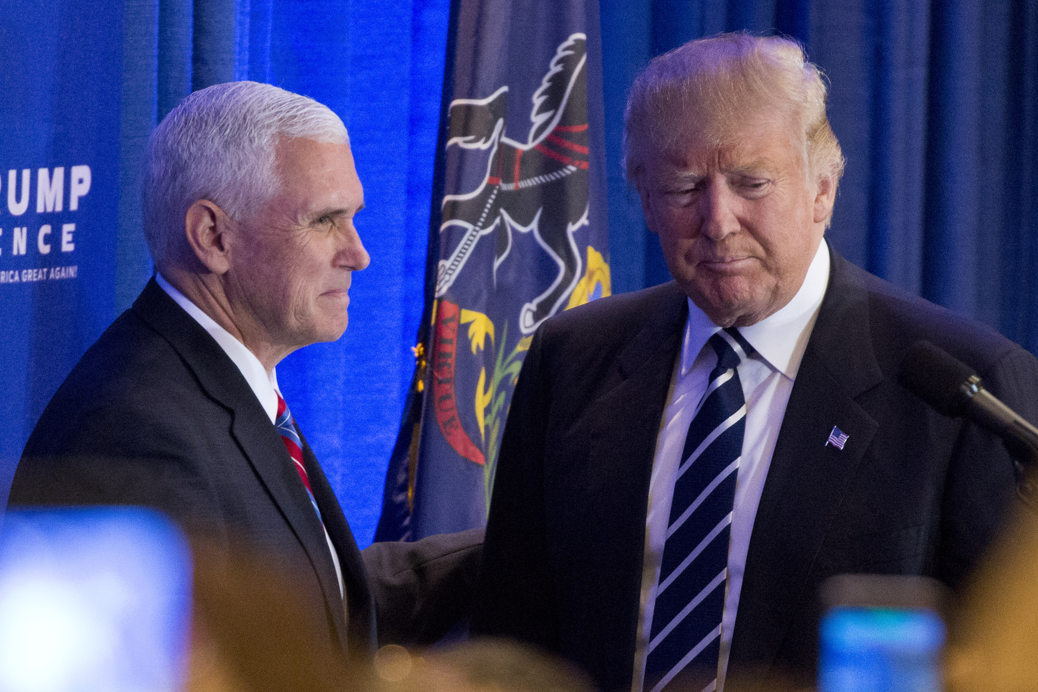 Republican presidential nominee Donald Trump greets his running mate Mike Pence before speaking at a private gathering in King of Prussia, Pennsylvania on November 1, 2016. / AFP PHOTO / DOMINICK REUTER